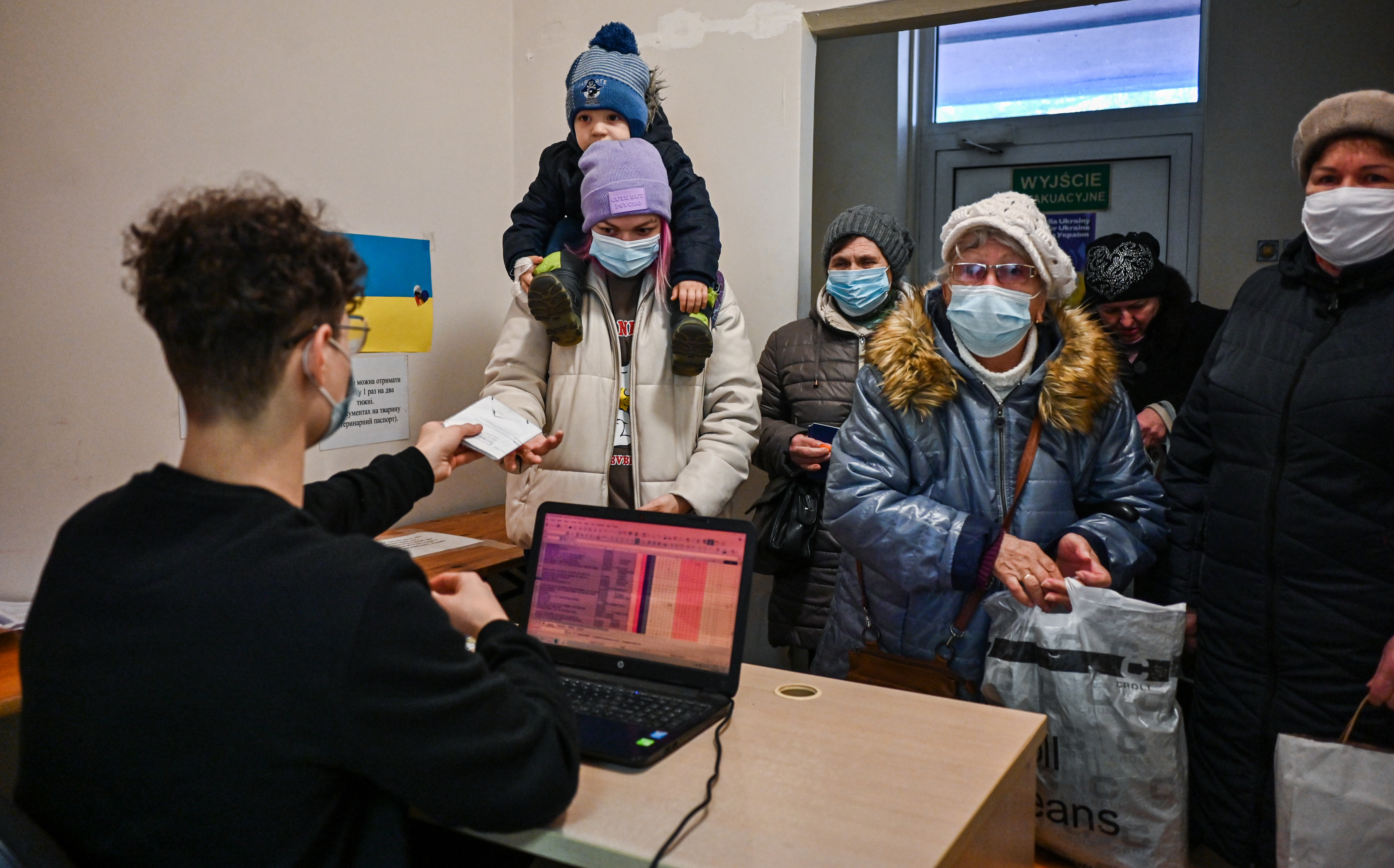 Um grupo de mulheres refugiadas espera para receber comida e outros itens na sede da Zupa dla Ukrainy (sopa para ucranianos) em Cracóvia em 24 de fevereiro.
