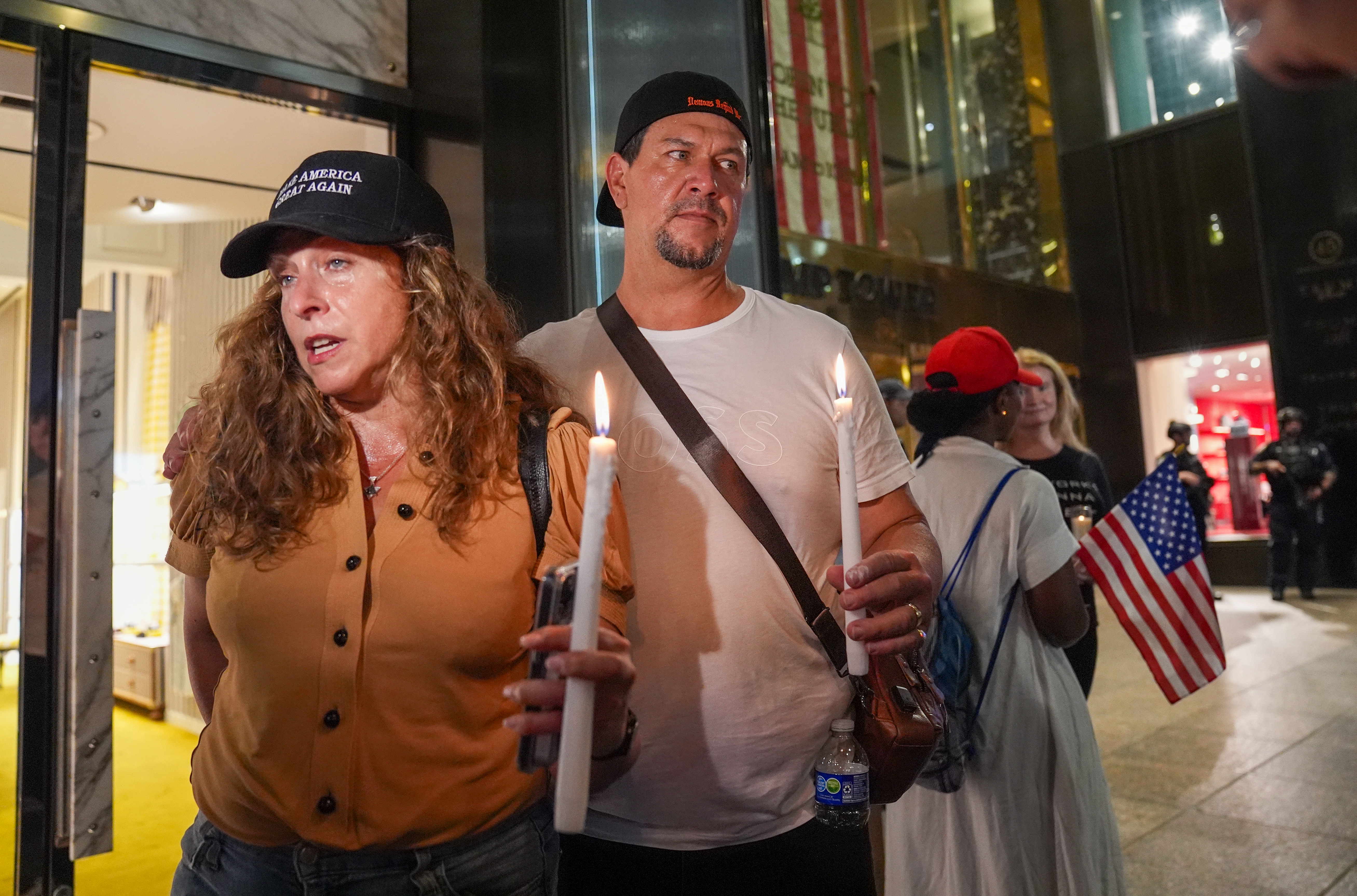 NEW YORK CITY, UNITED STATES - JULY 13: A few Trump supporters gather with candles in front of Trump Tower in New York as New York City Police Department (NYPD) has increased security at Trump Tower and other landmarks on Saturday, July 13, 2024 after shots fired at Trump rally in Pennsylvania, United States. (Photo by Selcuk Acar/Anadolu via Getty Images)
