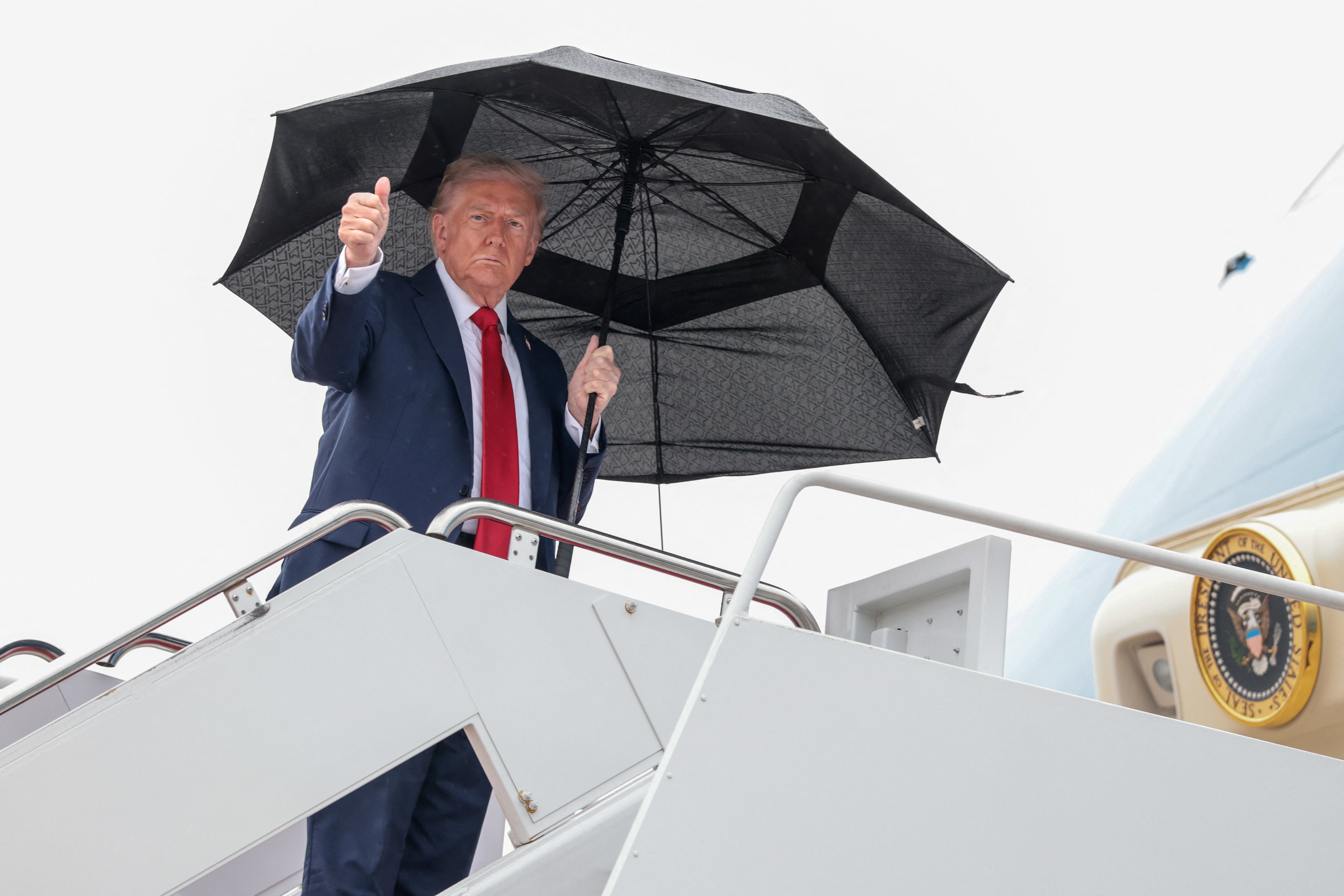 U.S. President Donald Trump gives a thumbs up while boarding Air Force One, as he departs for Israel, at Joint Base Andrews, Maryland, U.S., October 12, 2025. REUTERS/Evelyn Hockstein  