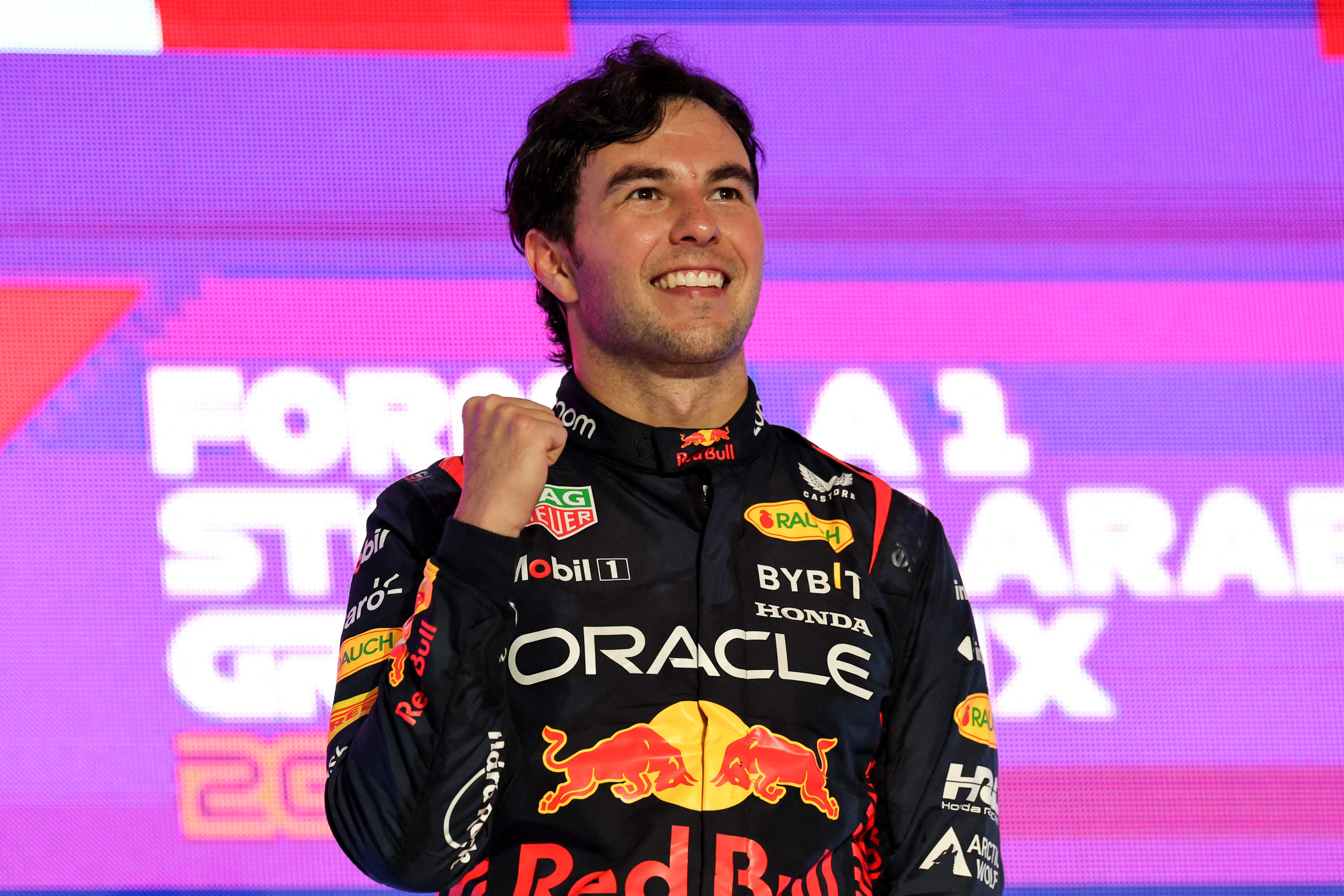 Red Bull Racing's Mexican driver Sergio Perez celebrates on the podium after winning the Saudi Arabia Formula One Grand Prix at the Jeddah Corniche Circuit in Jeddah on March 19, 2023. (Photo by Giuseppe CACACE / AFP)