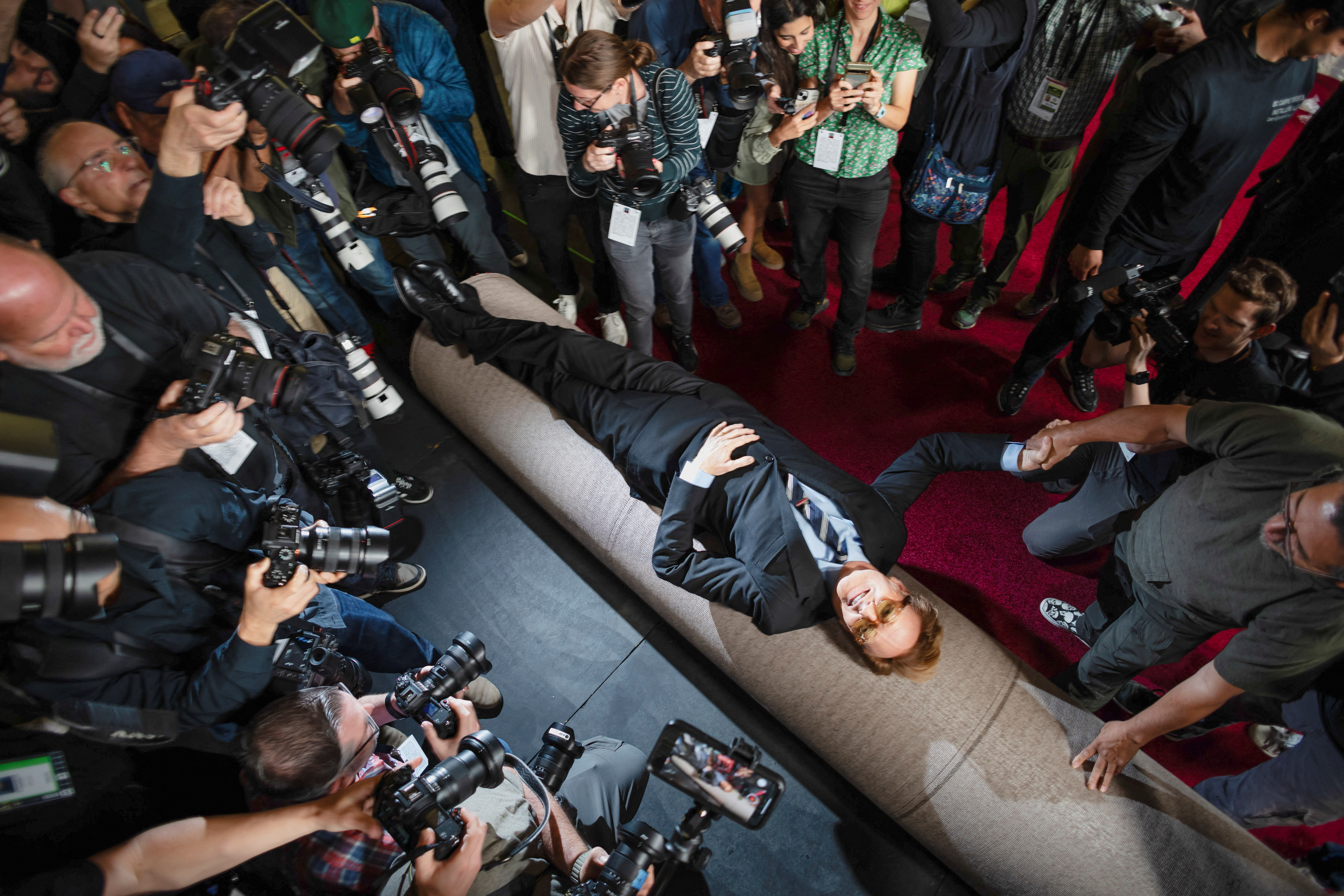 Academy Awards host Conan O'Brien lies over the red carpet during its rollout for the 97th Academy Awards in Los Angeles, California, U.S., February 26, 2025. REUTERS/Carlos Barria