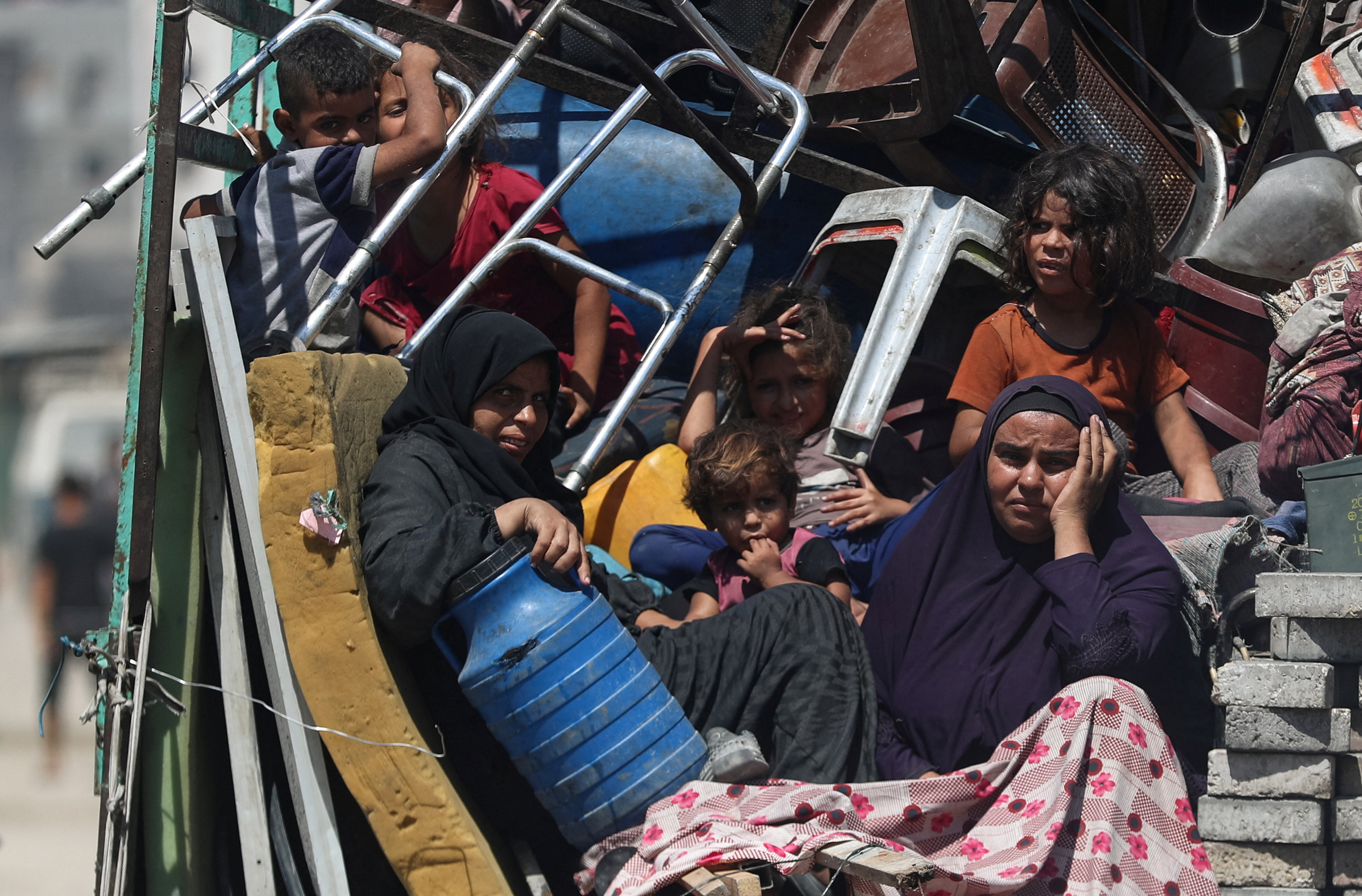Displaced Palestinian women and children sit on a vehicle with their luggage as they flee amid an Israeli military operation, following an Israeli evacuation order, in Gaza City, September 9, 2025. REUTERS/Mahmoud Issa