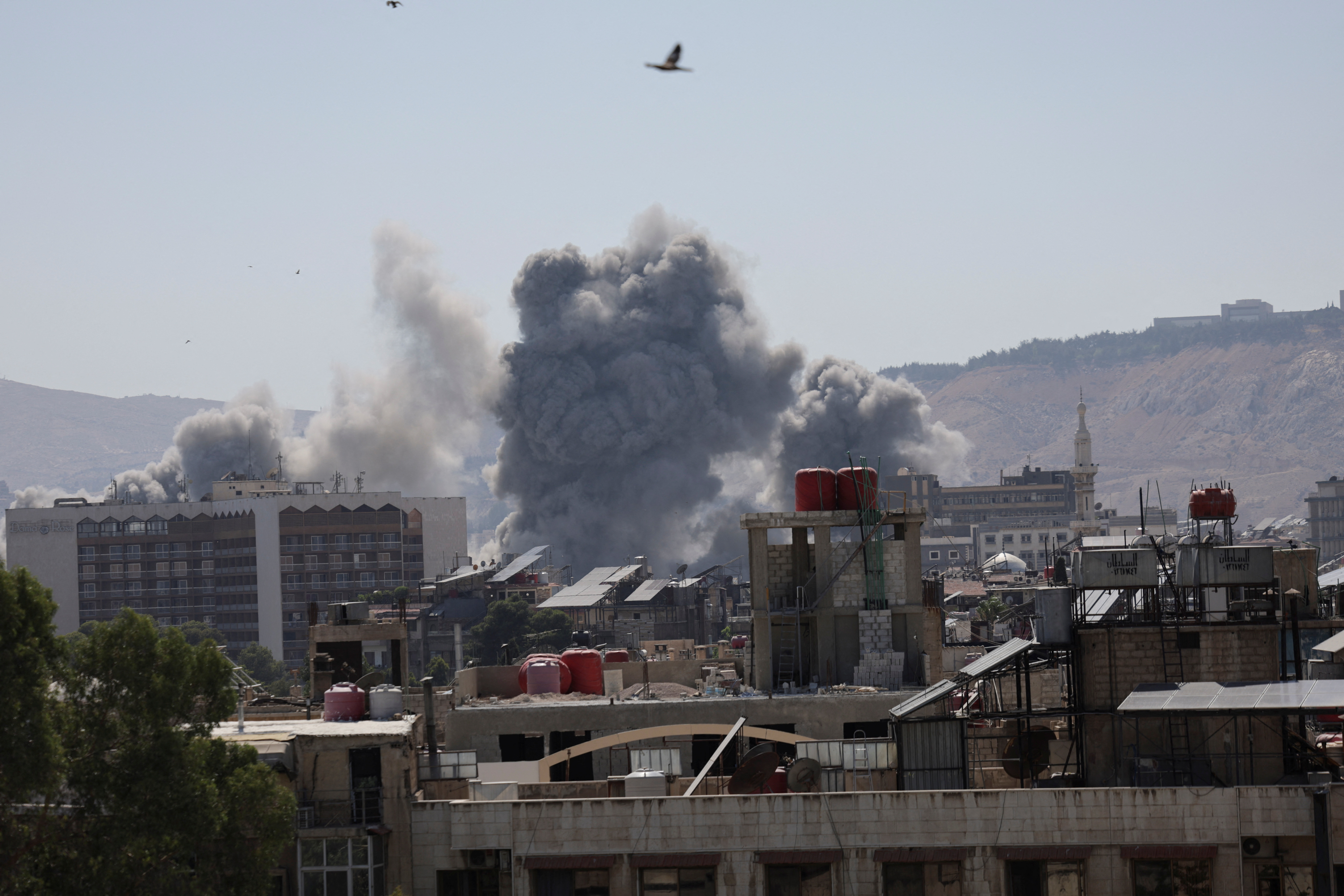 Smoke rises after strikes on Syria's defense ministry in Damascus, according to Al Jazeera TV, in Damascus, Syria July 16, 2025. REUTERS/Khalil Ashawi