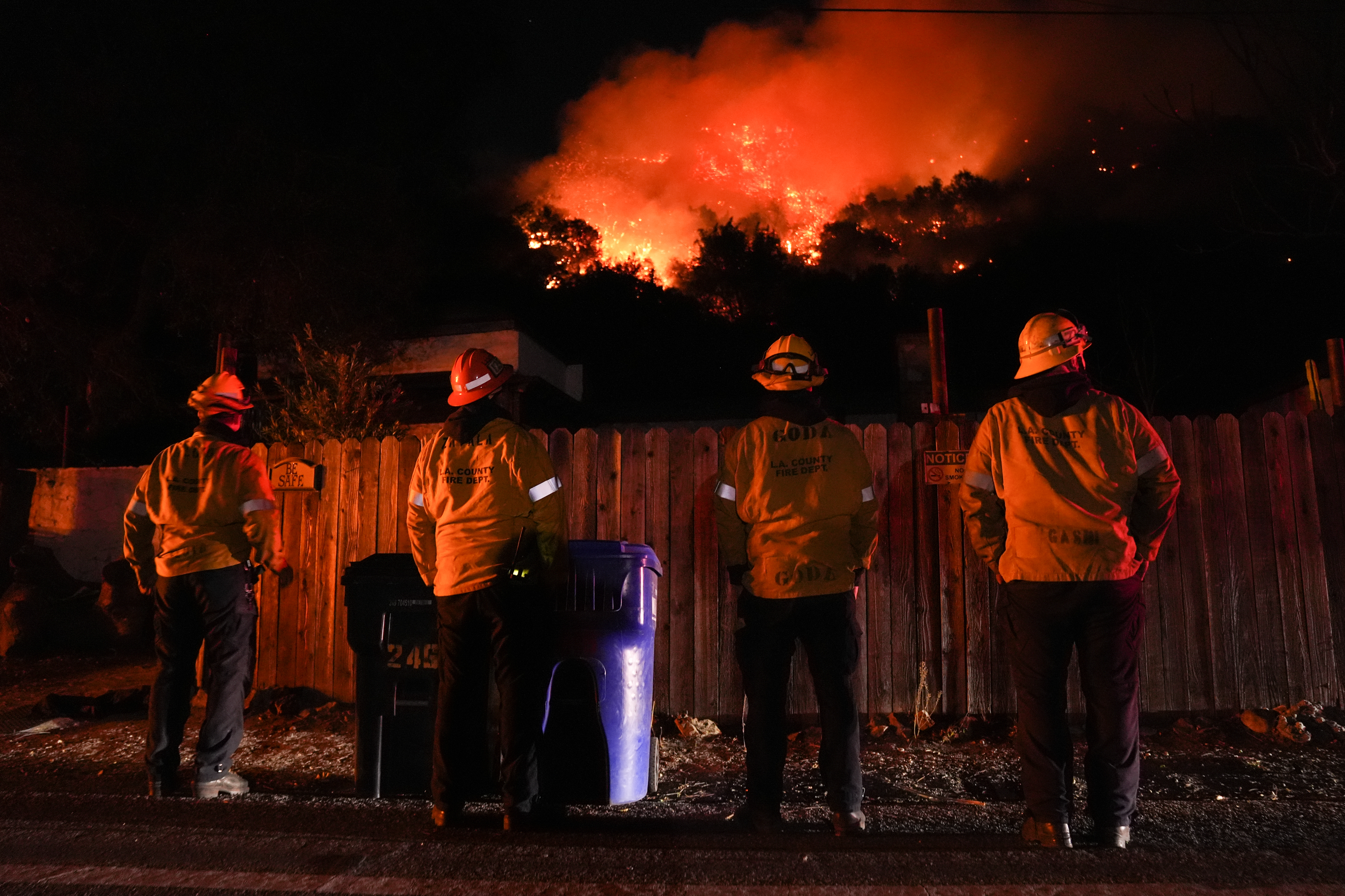 LOS ANGELES, US - JANUARY 10: Firefighters from the Los Angeles County Fire Department stand vigilant as they battle wildfires in Los Angeles while several blazes continue to tear through the region on January 10, 2025. The Palisades Fire, now the largest wildfire, has consumed nearly 20,000 acres, while the Kenneth Fire, which erupted Thursday afternoon, has quickly spread over 800 acres. As the death toll rises to 10, authorities continue their search for victims. The fires have destroyed thousands of homes and caused widespread damage across the city. (Photo by Lokman Vural Elibol/Anadolu via Getty Images)