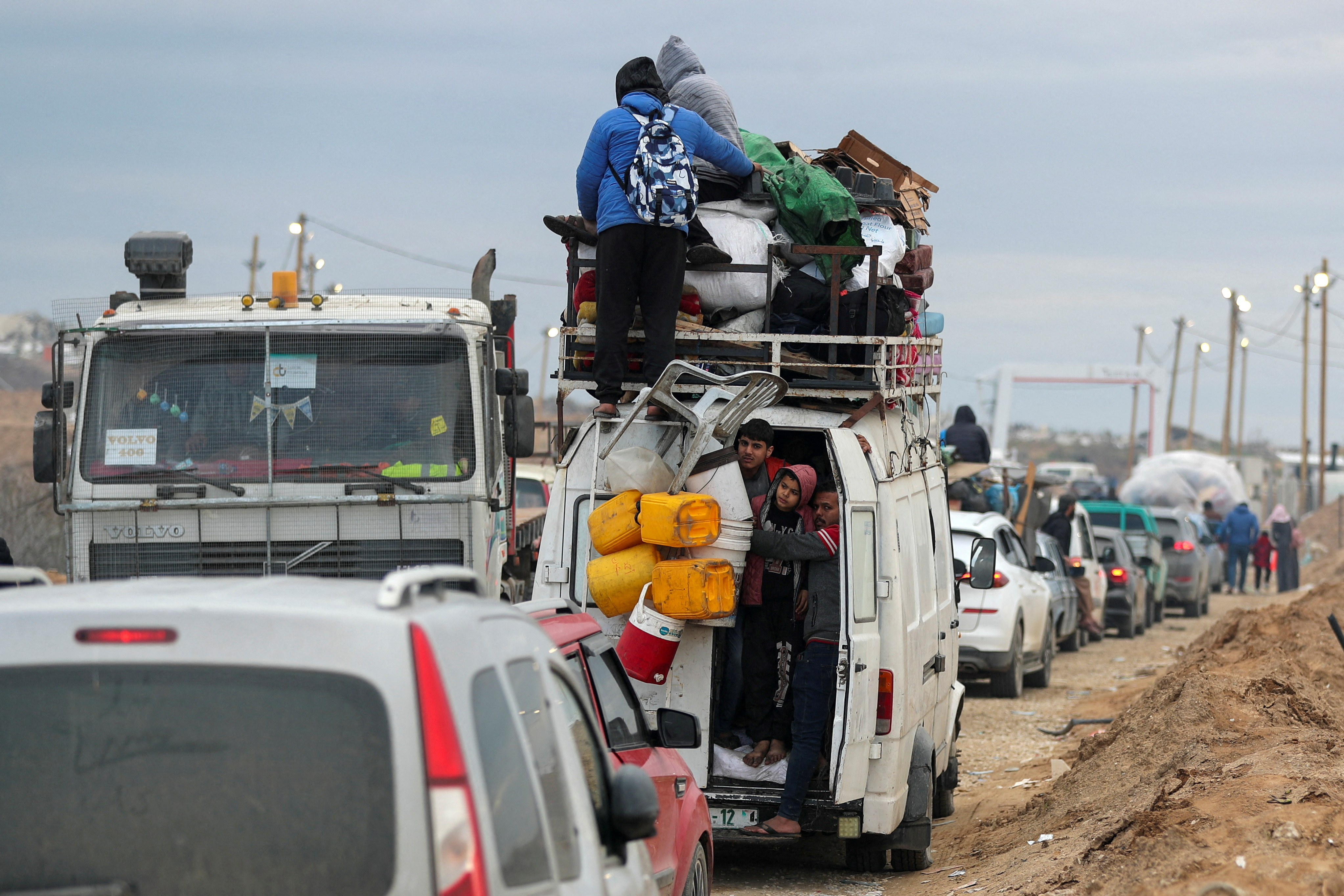 Palestinians wait to cross through a checkpoint run by U.S. and Egyptian security contractors after Israeli forces withdrew from the Netzarim Corridor, allowing people to travel in both directions between southern and northern Gaza, amid a ceasefire between Israel and Hamas, near Gaza City, February 9, 2025. REUTERS/Dawoud Abu Alkas     TPX IMAGES OF THE DAY     