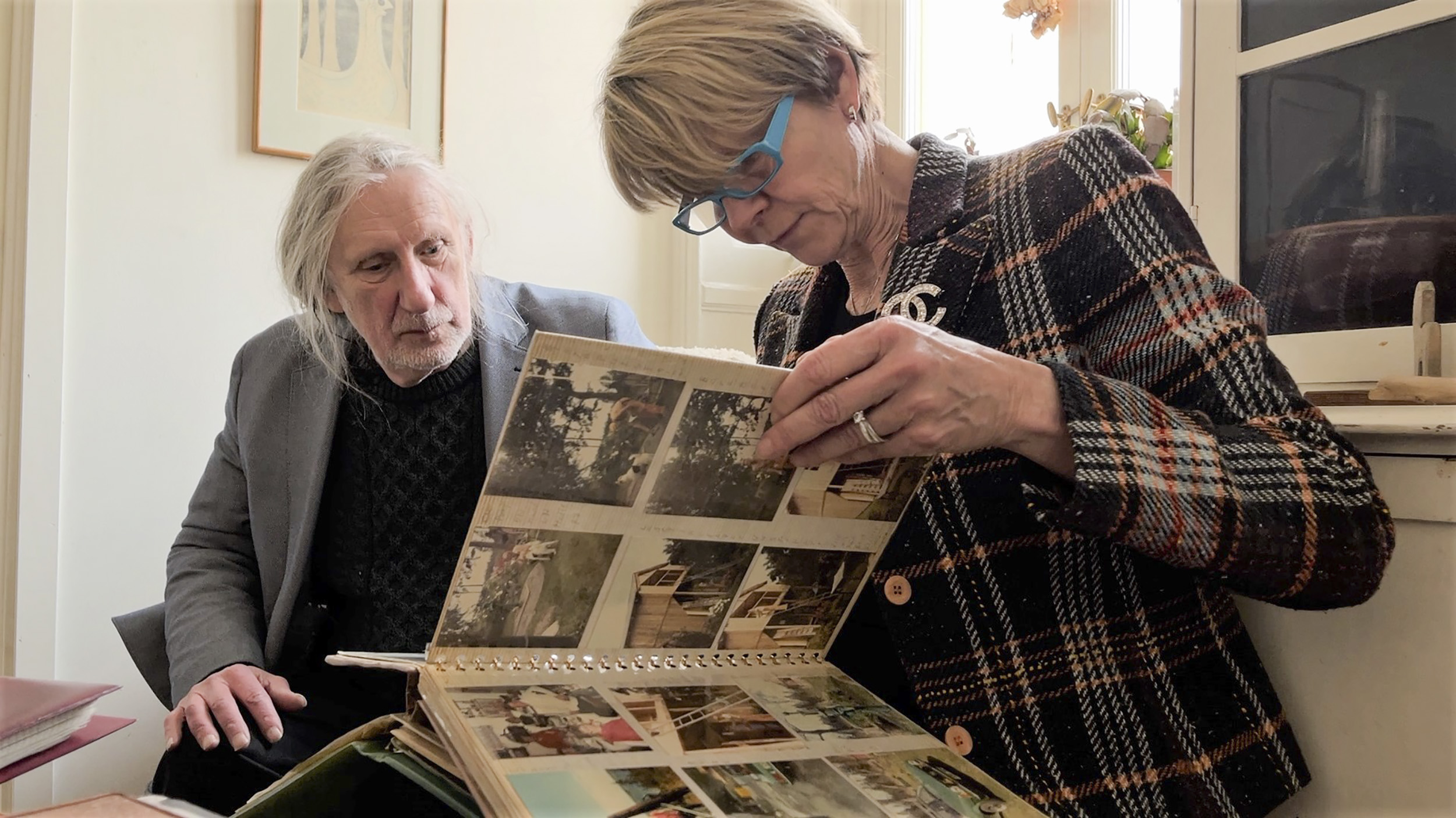 Kjell Sundstedt and his cousin Karina Sjöberg with a photo album of their family, who were institutionalized and sterilized in Sweden.