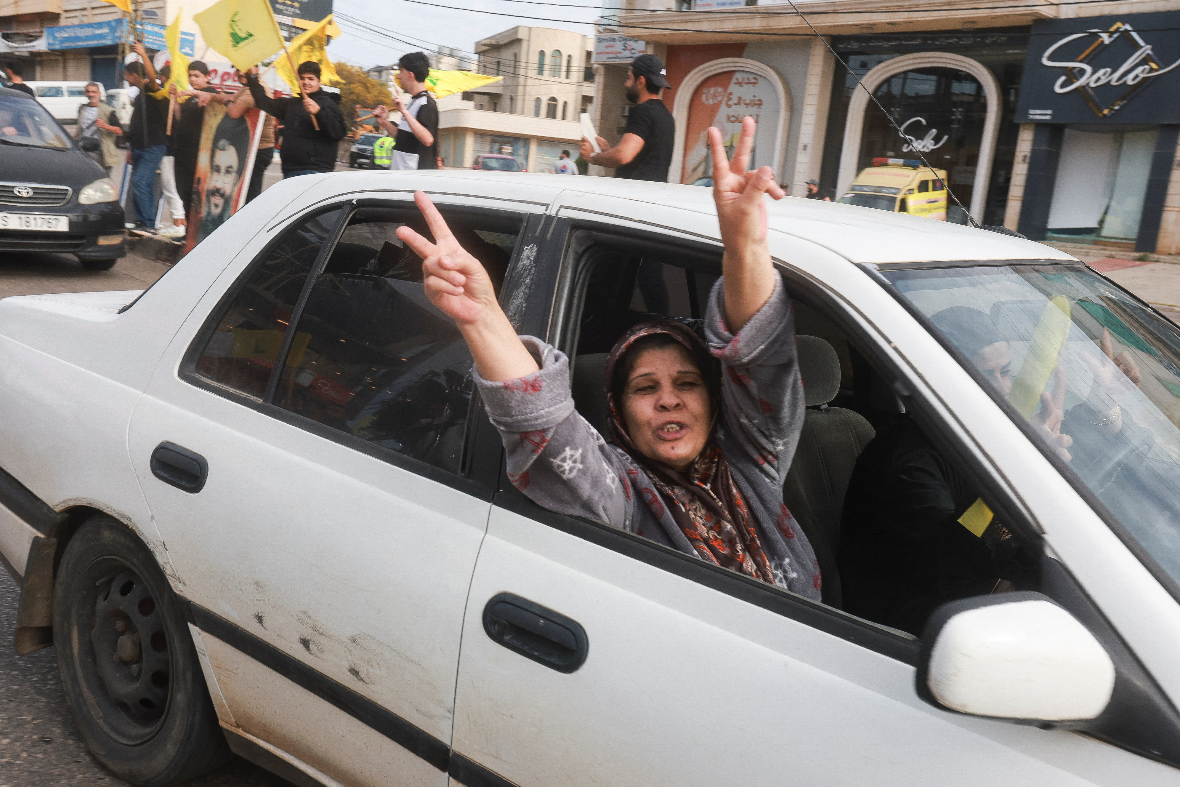 Una mujer celebra el alto el fuego en Líbano mientras regresa a su domicilio en Nabatieh