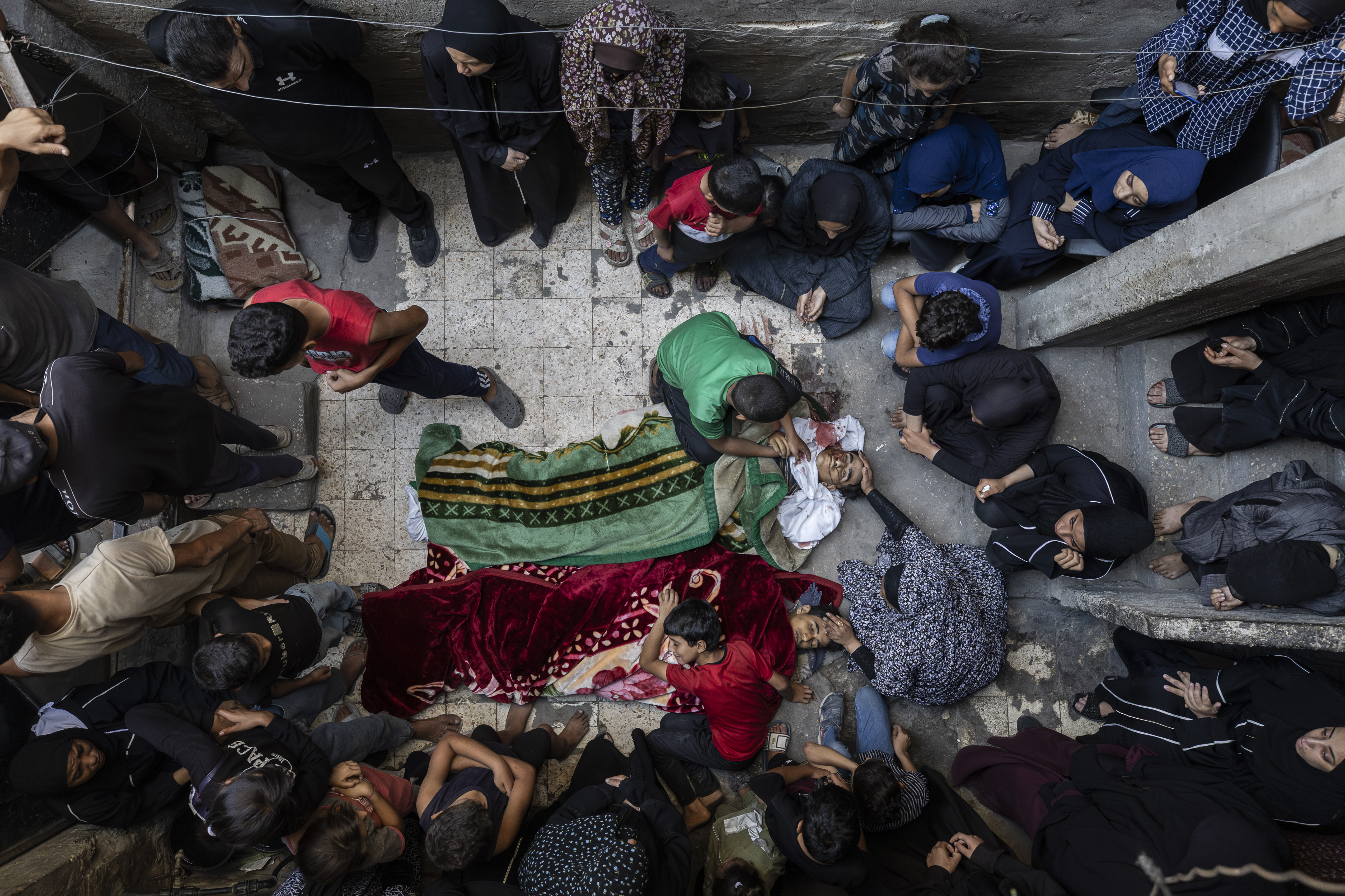 GAZA CITY, GAZA - SEPTEMBER 26:  (EDITORS NOTE: Image depicts death) People attend the funeral of Palestinian brothers Beraa Al-Kreynavi and Nihad Al-Kreynavi, died after Israeli army snipers opened fire on people trying to collect aid parcels at Nuseyrat Refugee Camp in Gaza City, Gaza on September 26, 2025. (Photo by Mahmoud Abu Hamda/Anadolu via Getty Images)