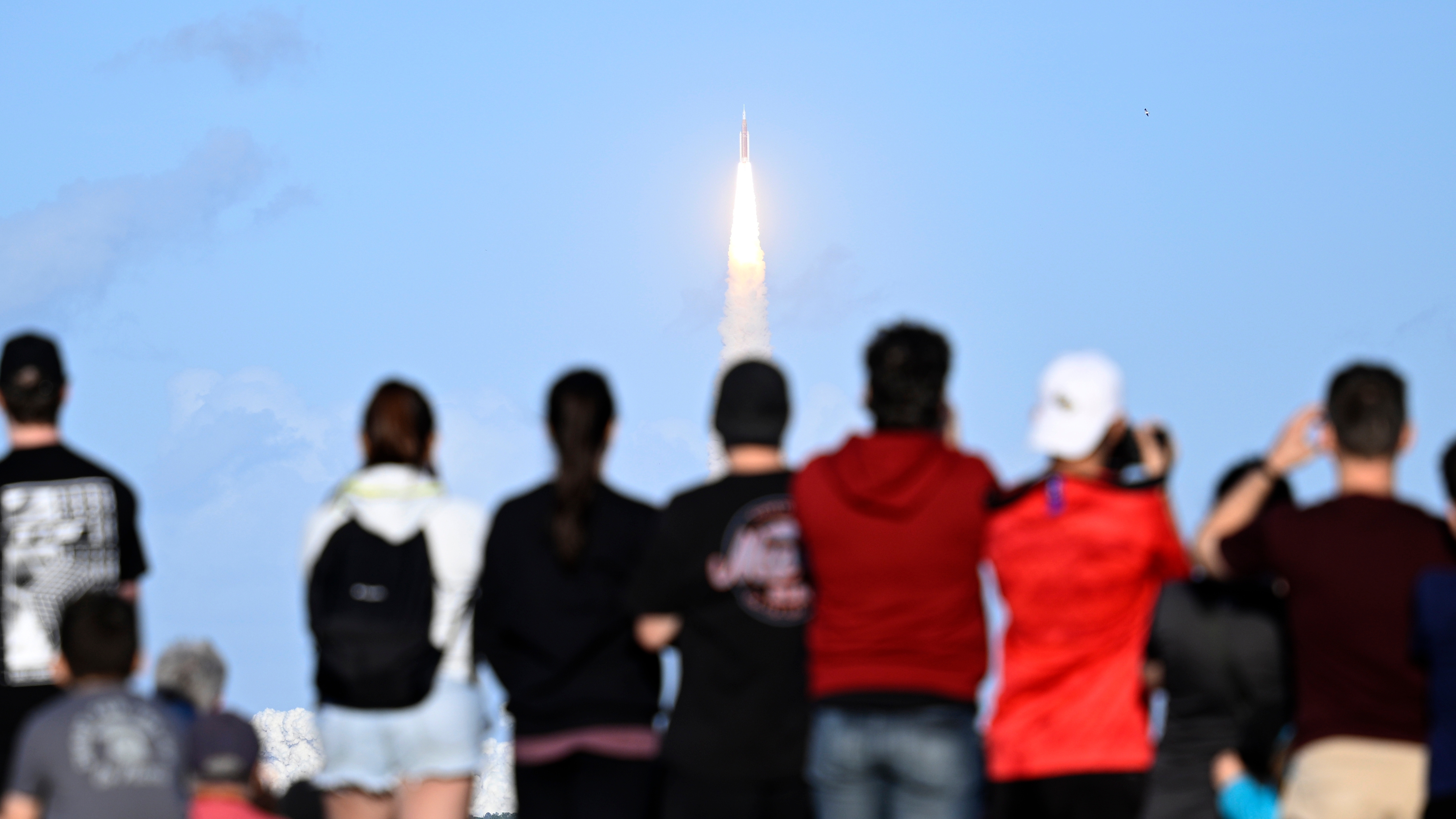 Spectators look on from the A. Max Brewer Bridge as NASA's Artemis II moon rocket lifts off Wednesday, April 1, 2026, as seen from Titusville, Fla. (AP Photo/Phelan M. Ebenhack)