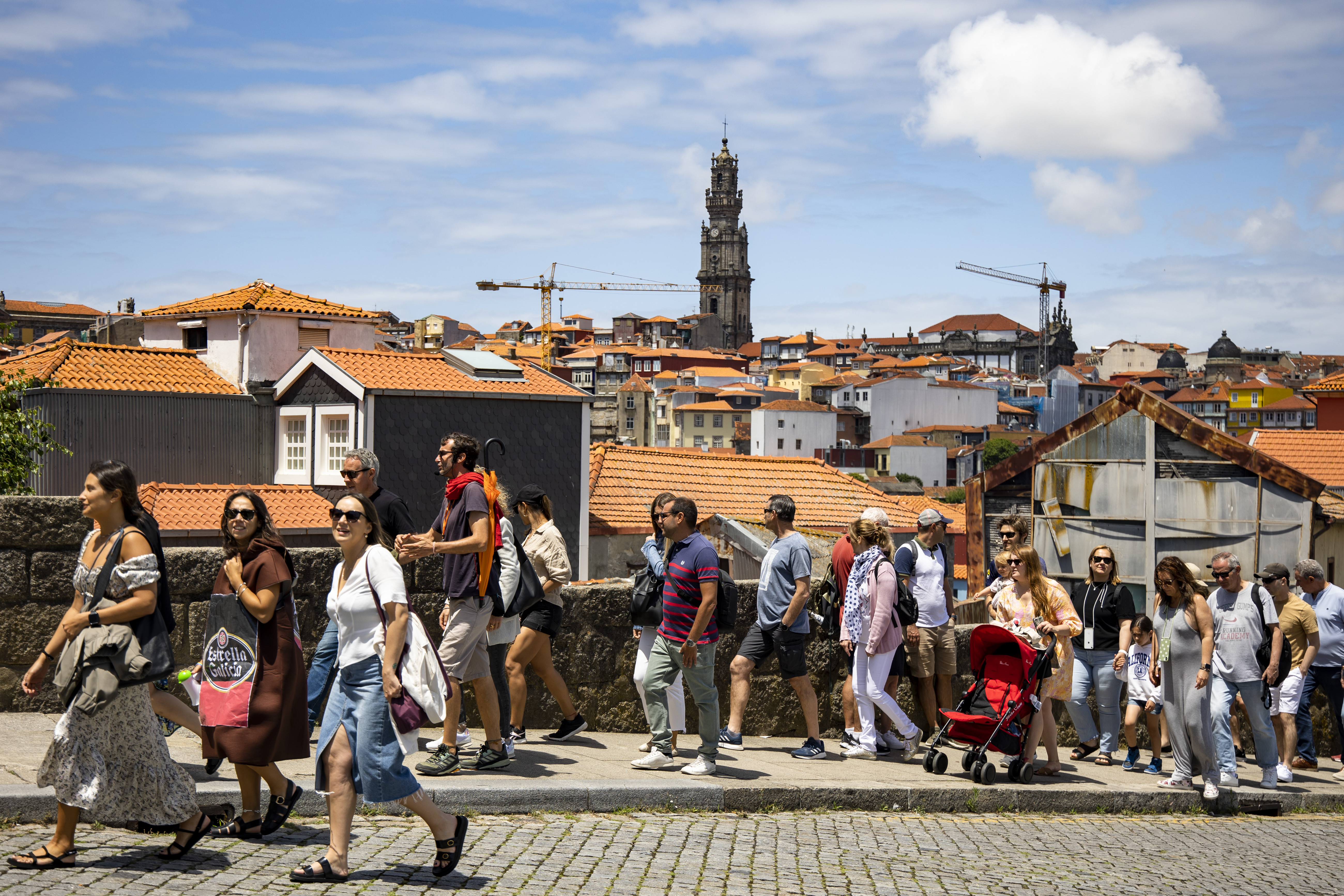 Tourists walk towards the Se do Porto (Cathedral) in Porto, Portugal on June 25, 2022. 