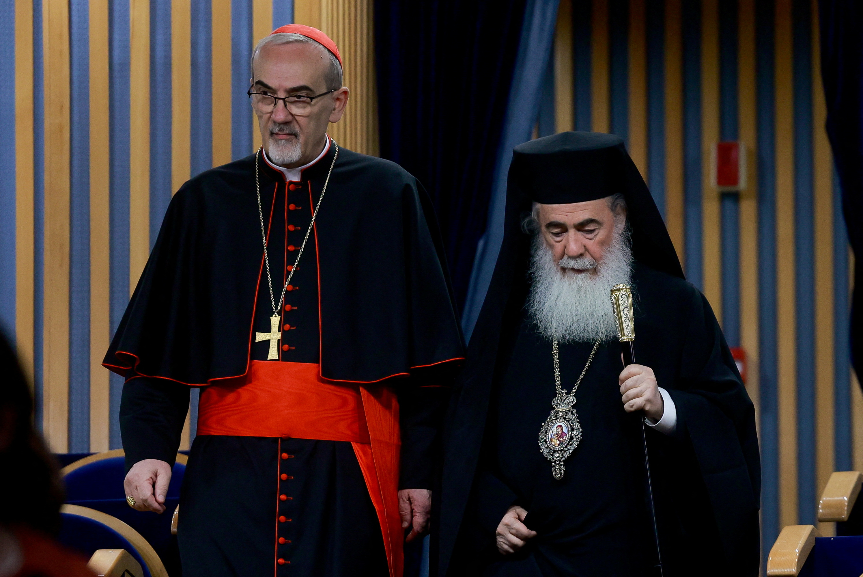 Latin Patriarch of Jerusalem Pierbattista Pizzaballa and Greek Orthodox Patriarch of Jerusalem Theophilos III walk to hold a /Ammar Awad