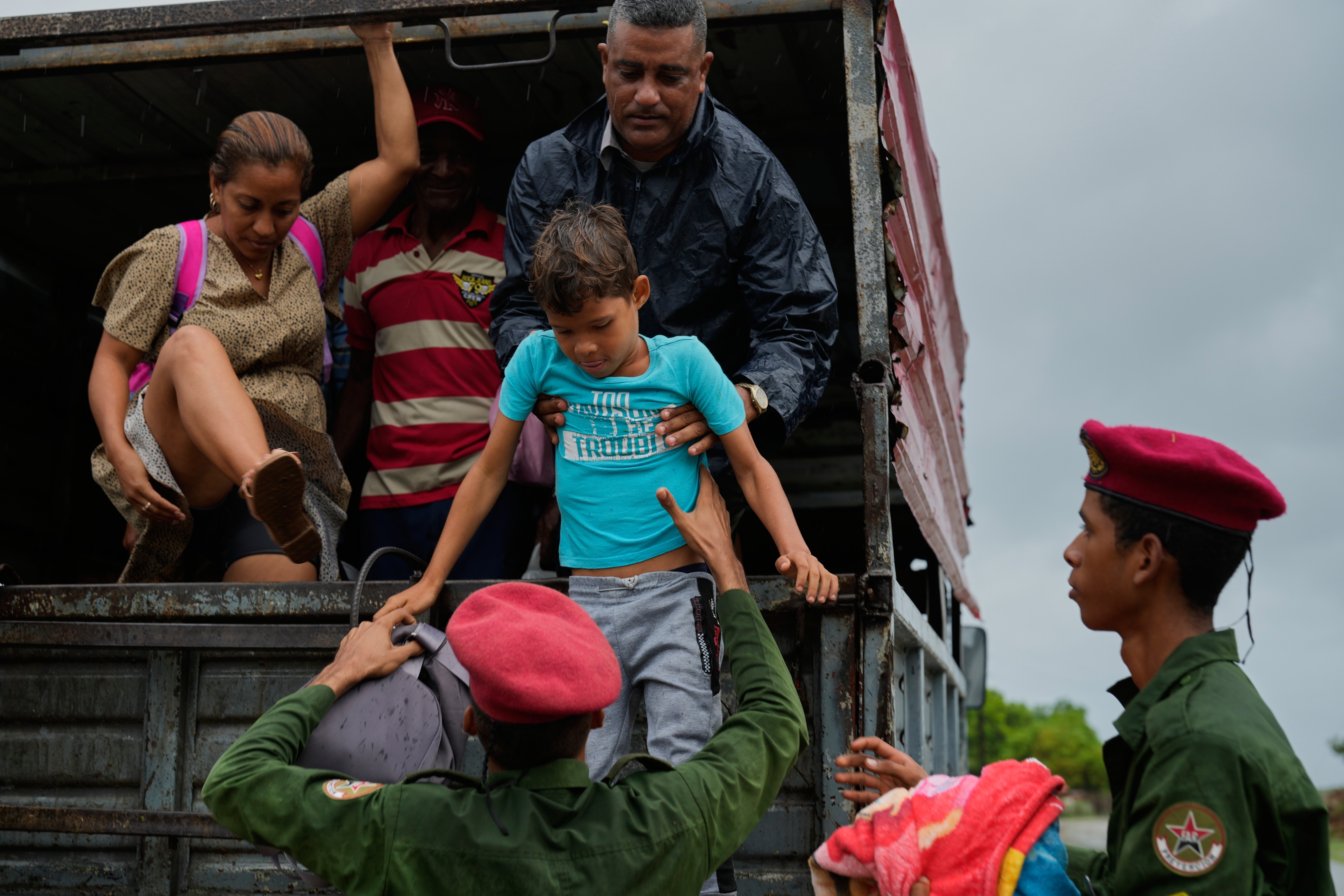 People evacuate before the arrival of Hurricane Melissa in Canizo, a community in Santiago de Cuba, Monday, Oct. 28, 2025. (AP Photo/Ramón Espinosa)