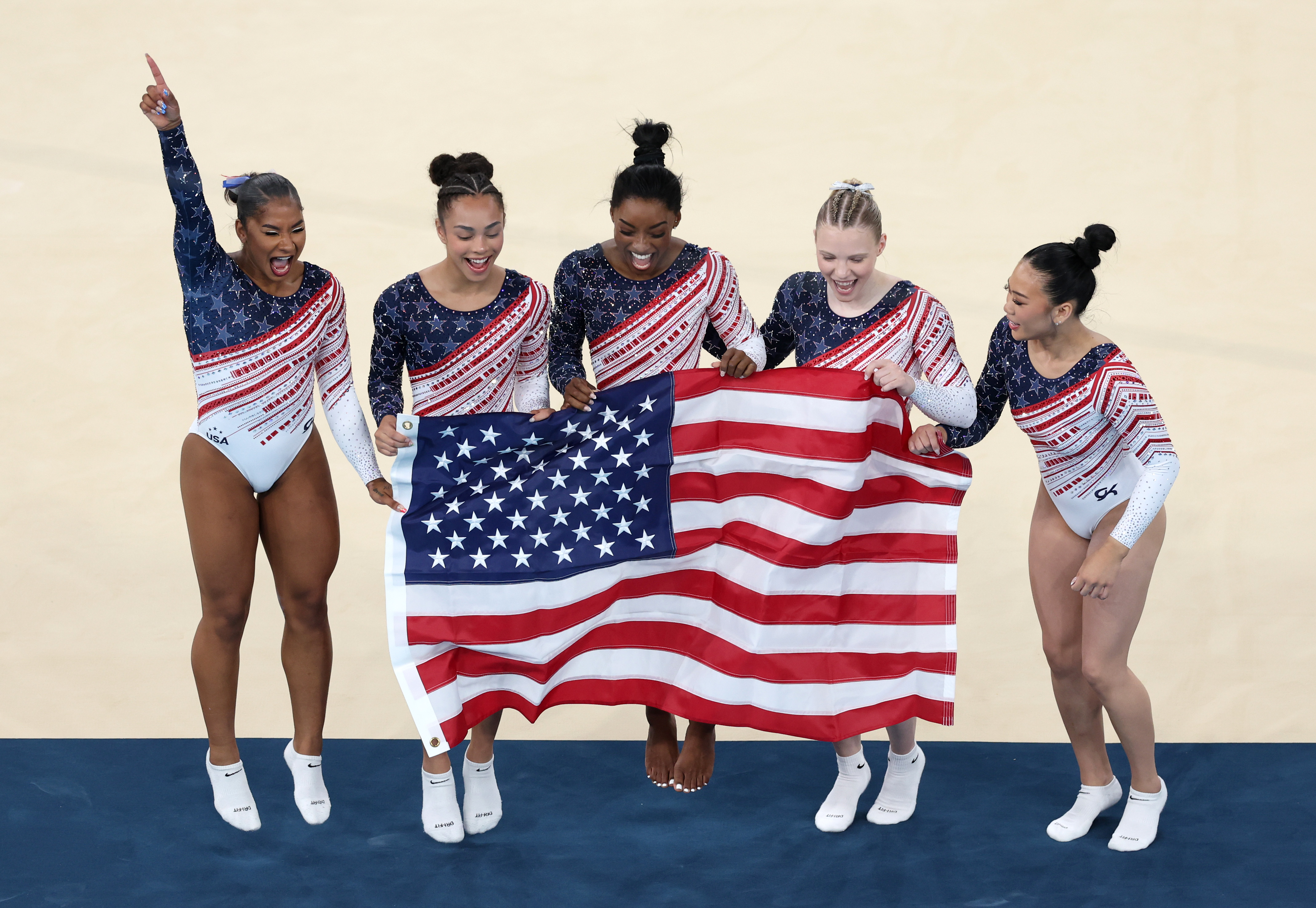 PARIS, FRANCE - JULY 30: (L-R) Jordan Chiles, Hezly Rivera,  Simone Biles, Jade Carey and Sunisa Lee of Team United States celebrate during the Artistic Gymnastics Women's Team Final on day four of the Olympic Games Paris 2024 at Bercy Arena on July 30, 2024 in Paris, France. (Photo by Ezra Shaw/Getty Images)