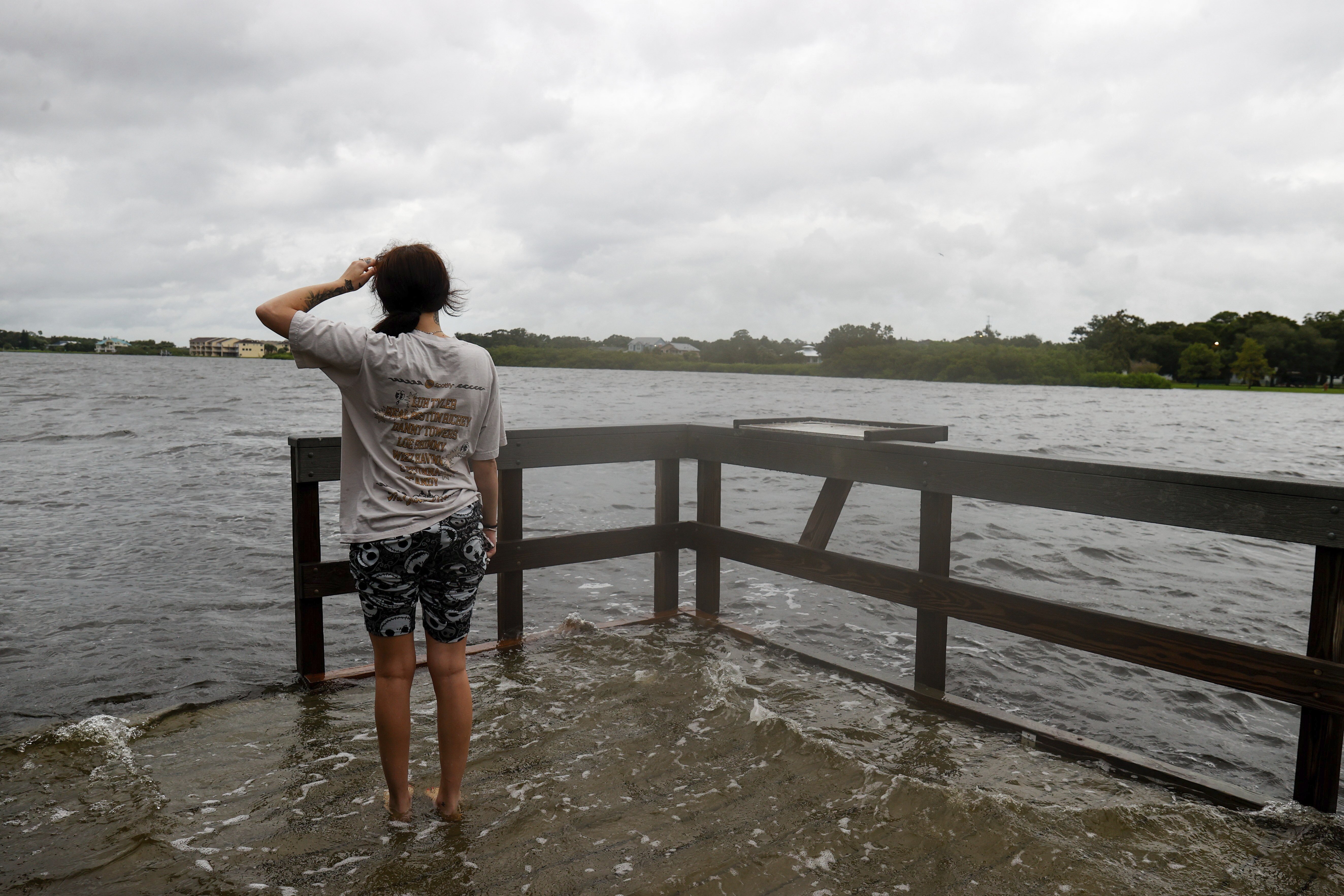 Chloe Gray, 19, of Safety Harbor wades in the water at the Oldsmar Pier before Hurricane Helene arrives on Thursday, Sept. 26, 2024, in Oldsmar, Fla. (Jefferee Woo/Tampa Bay Times via AP)