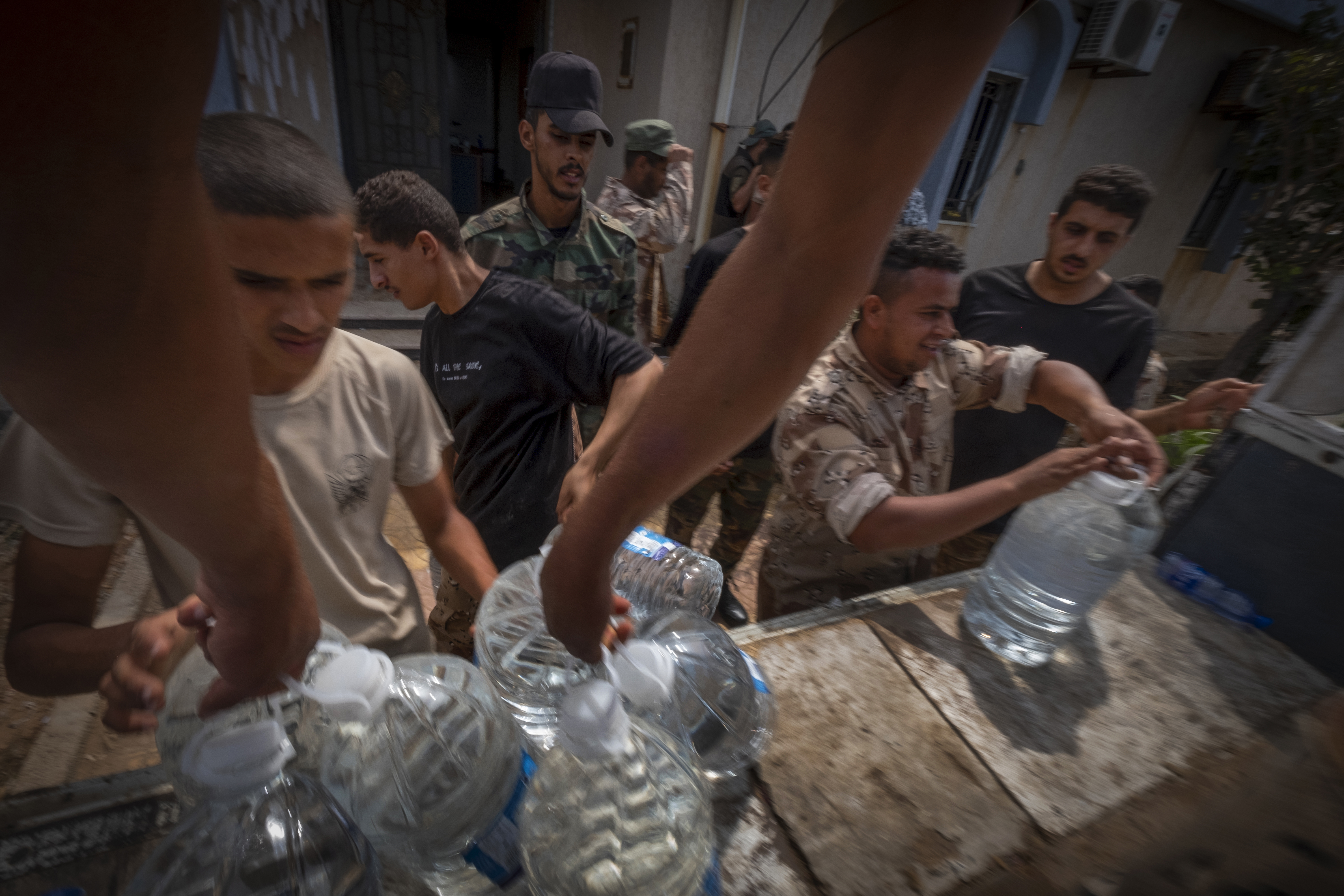 Um grupo de soldados participa na distribuição de água à população de Derna (Líbia). 