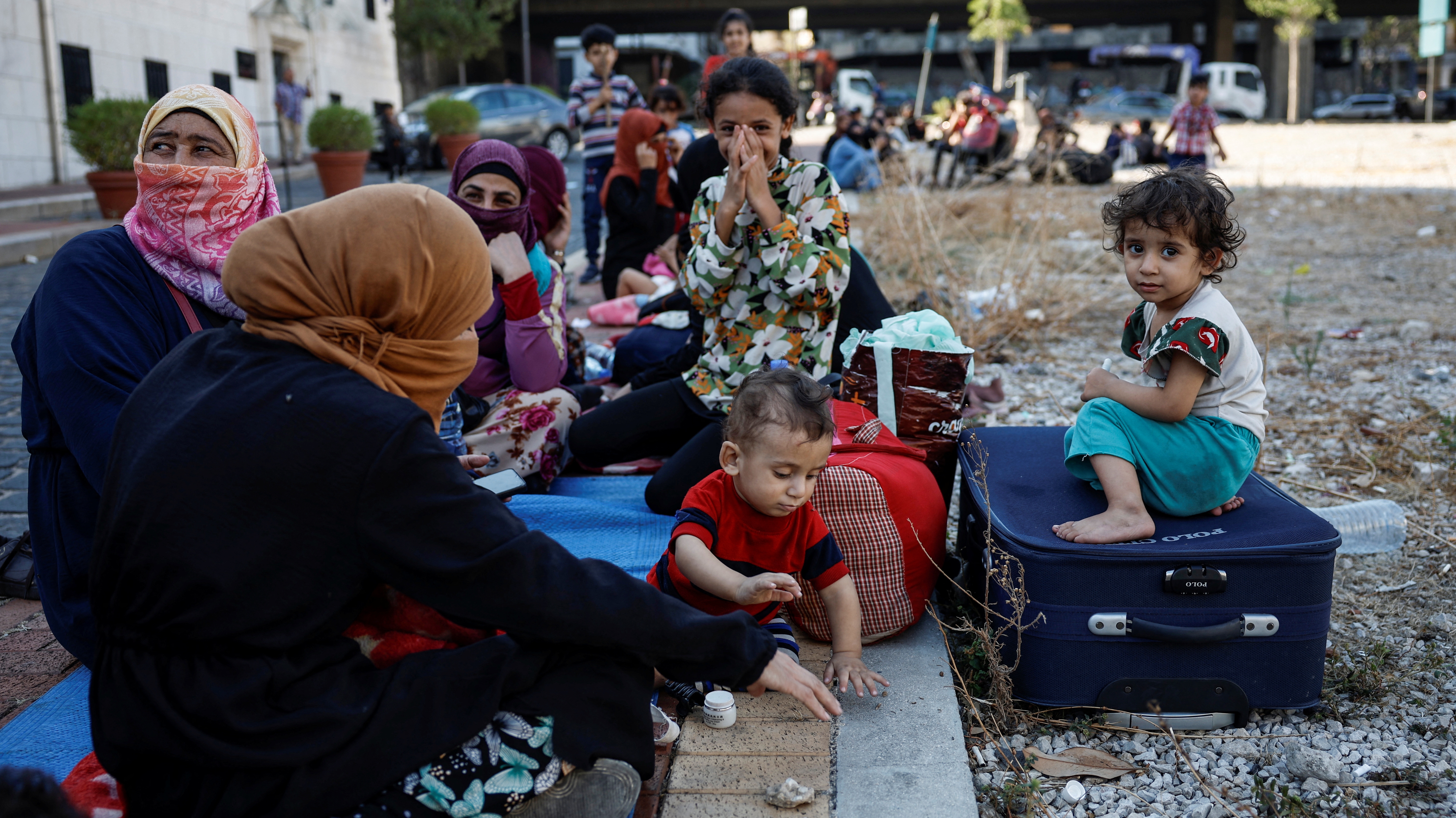 Displaced families gather near a church after spending the night there, fleeing the overnight Israeli strikes in Beirut, Lebanon September 28, 2024. REUTERS/Louisa Gouliamaki