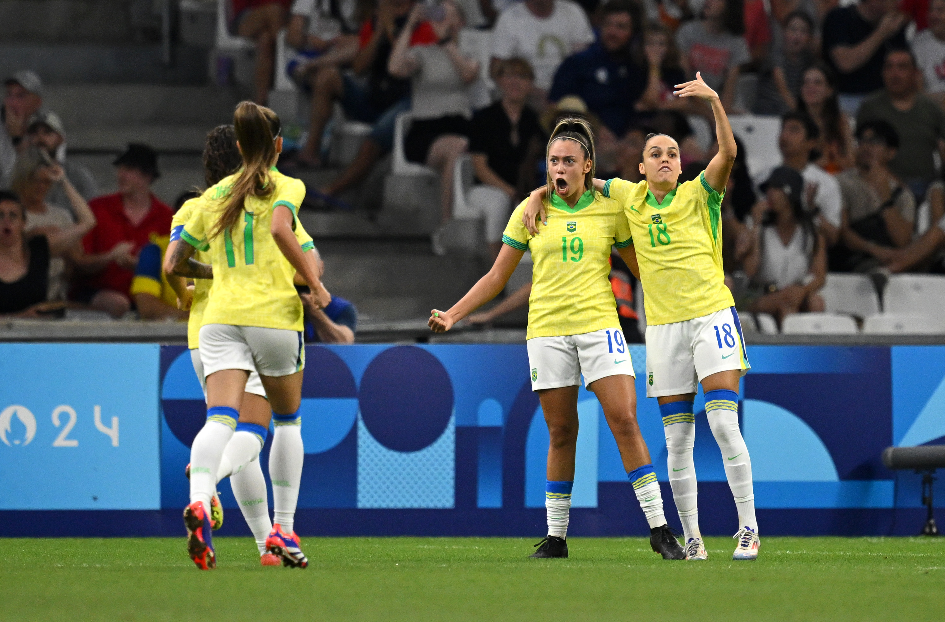 MARSEILLE, FRANCE - AUGUST 06: Priscila #19 and Gabi Portilho #18 of Team Brazil celebrate the team's first goal scored by an own goal from Irene Paredes #4 of Team Spain (not in frame) during the Women's semifinal match between Brazil and Spain during the Olympic Games Paris 2024 at Stade de Marseille on August 06, 2024 in Marseille, France. (Photo by Clive Mason/Getty Images)