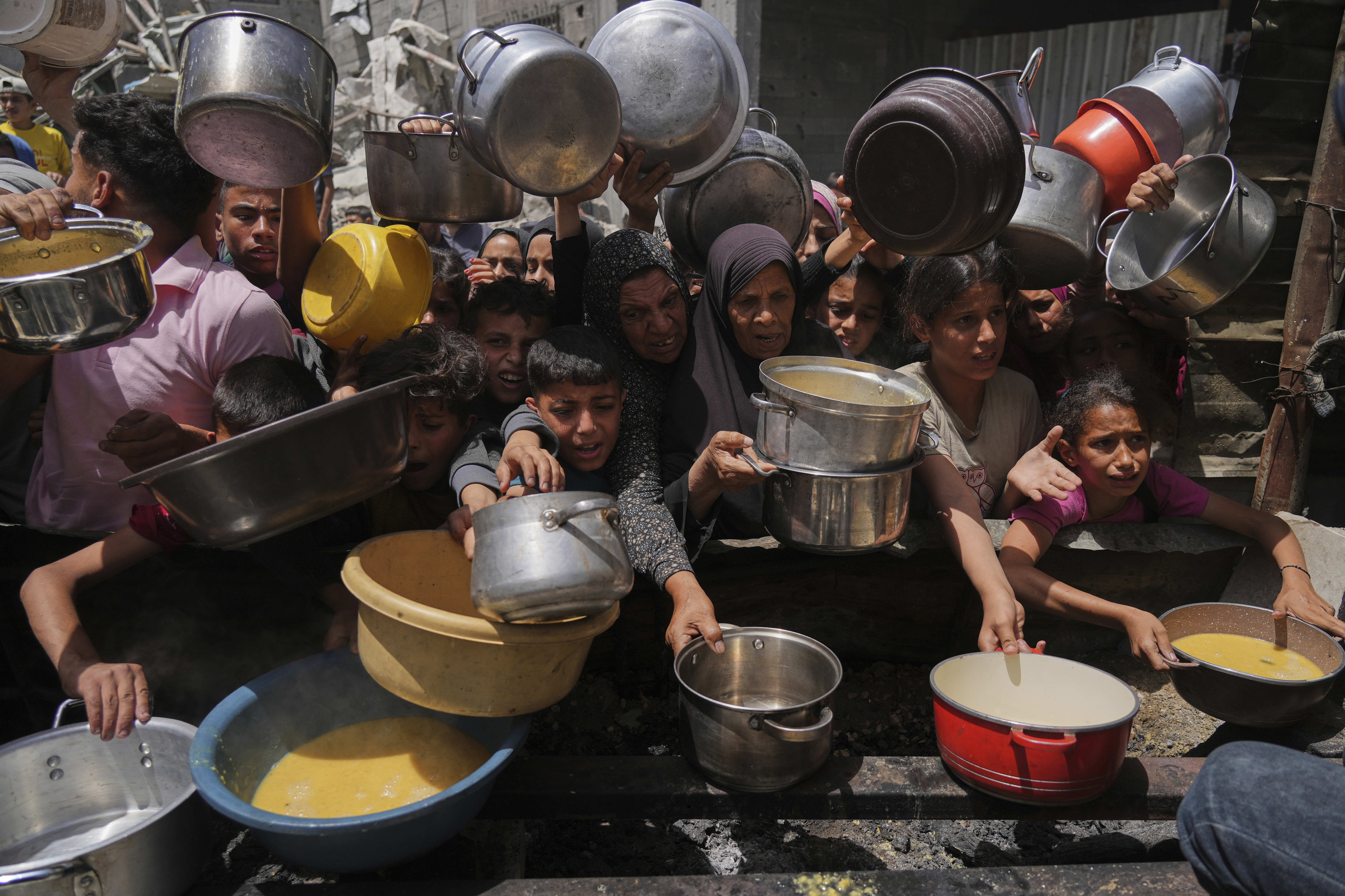 Un grupo de personas busca comida en una cocina comunitaria en Yabalia, en el norte de la Franja, este lunes 19 de mayo de 2025
