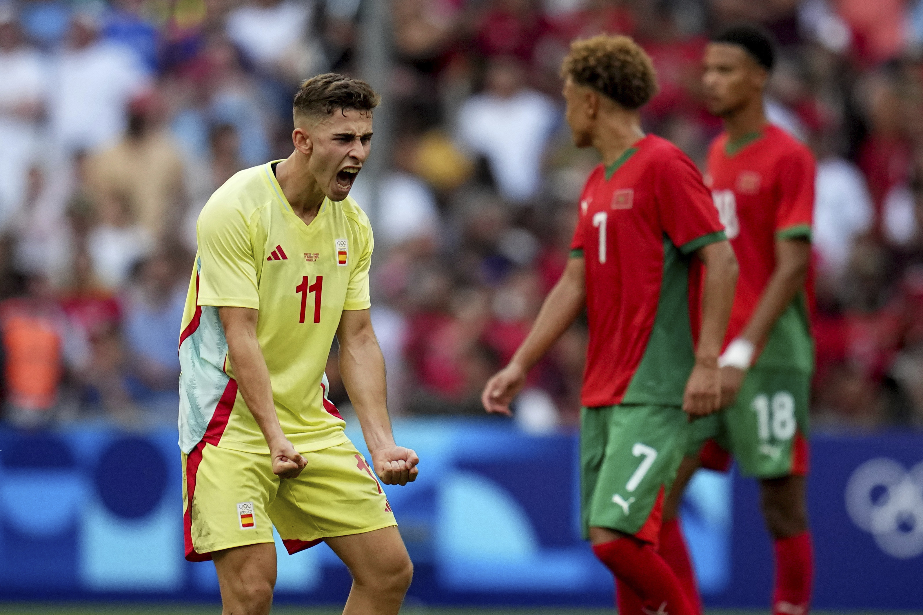 Spain's Fermin Lopez celebrates is side's first goal during a men's semifinal soccer match between Morocco and Spain at the 2024 Summer Olympics, Monday, Aug. 5, 2024, at Marseille Stadium in Marseille, France. (AP Photo/Daniel Cole)