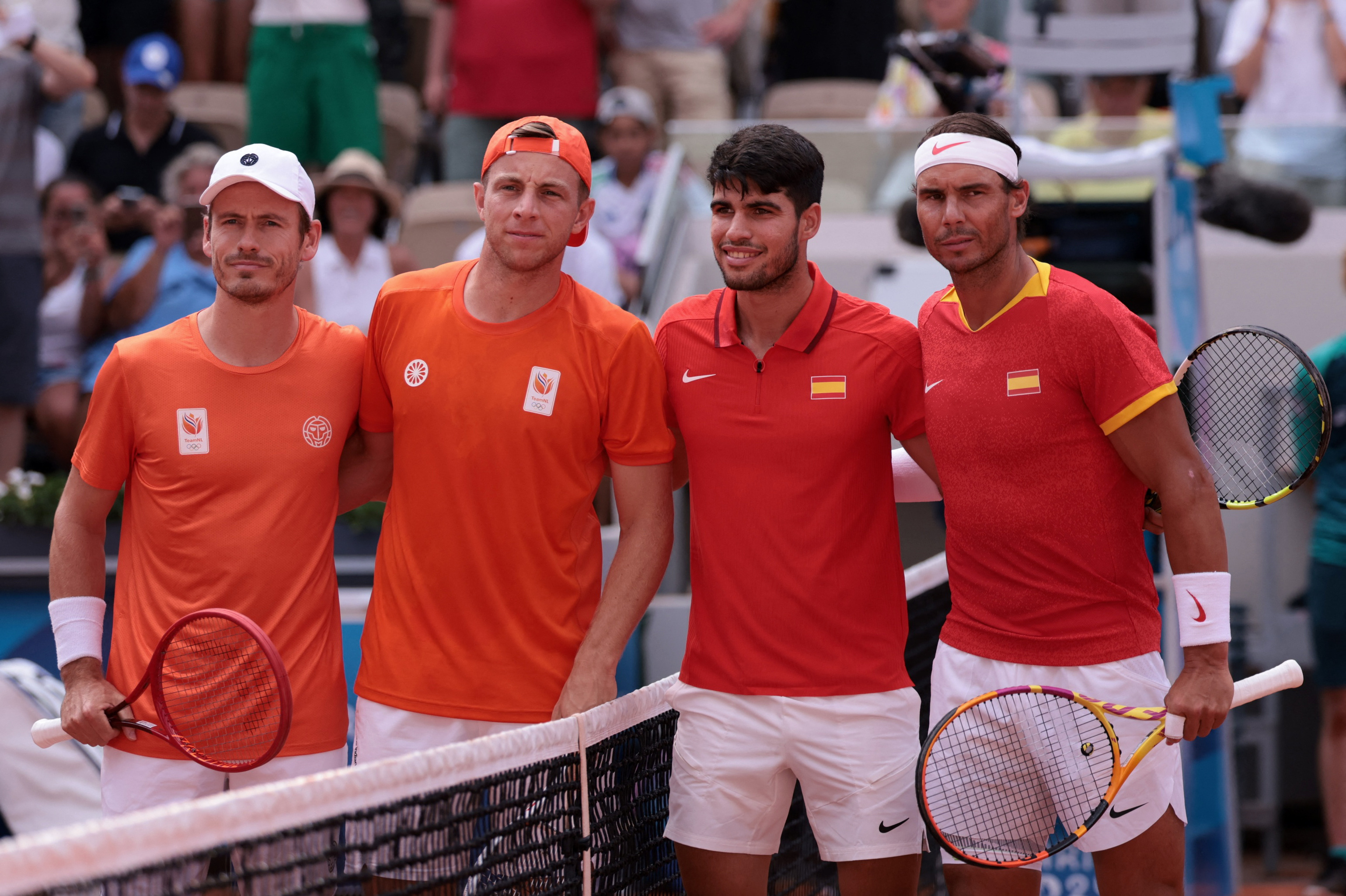 Paris 2024 Olympics - Tennis - Men's Doubles Second Round - Roland-Garros Stadium, Paris, France - July 30, 2024. Carlos Alcaraz of Spain and Rafael Nadal of Spain pose with Tallon Griekspoor of Netherlands and Wesley Koolhof of Netherland before their match. REUTERS/Claudia Greco