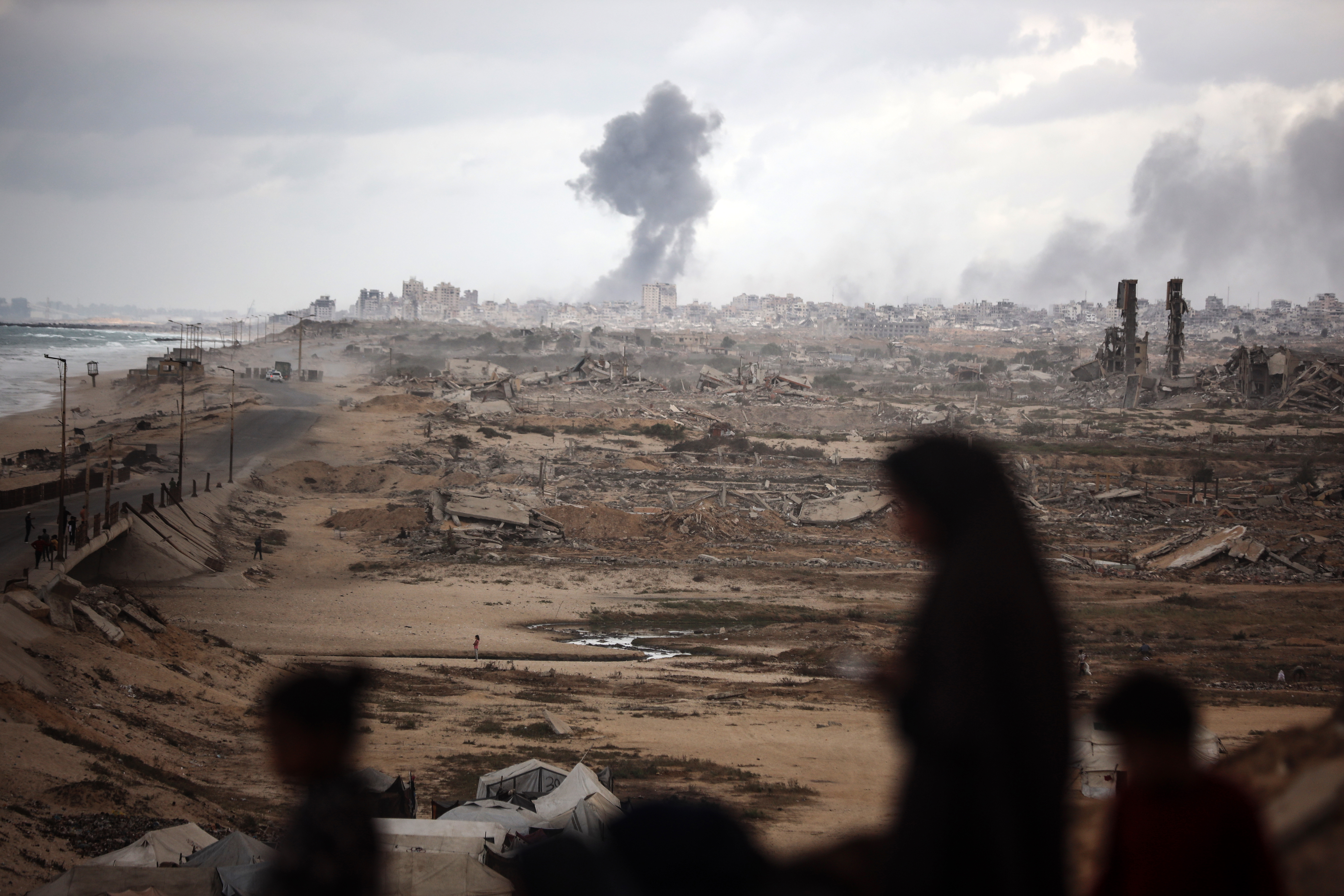 A smoke plume billows following Israeli bombardment on the Gaza Strip as seen from northwest of Nuseirat refugee camp in Gaza, on October 9, 2025. Israel and Hamas agree on a Gaza ceasefire deal on October 9 to free the remaining living hostages, in a major step towards ending a war that kills tens of thousands of people and unleashes a humanitarian catastrophe. (Photo by Majdi Fathi/NurPhoto via Getty Images)
