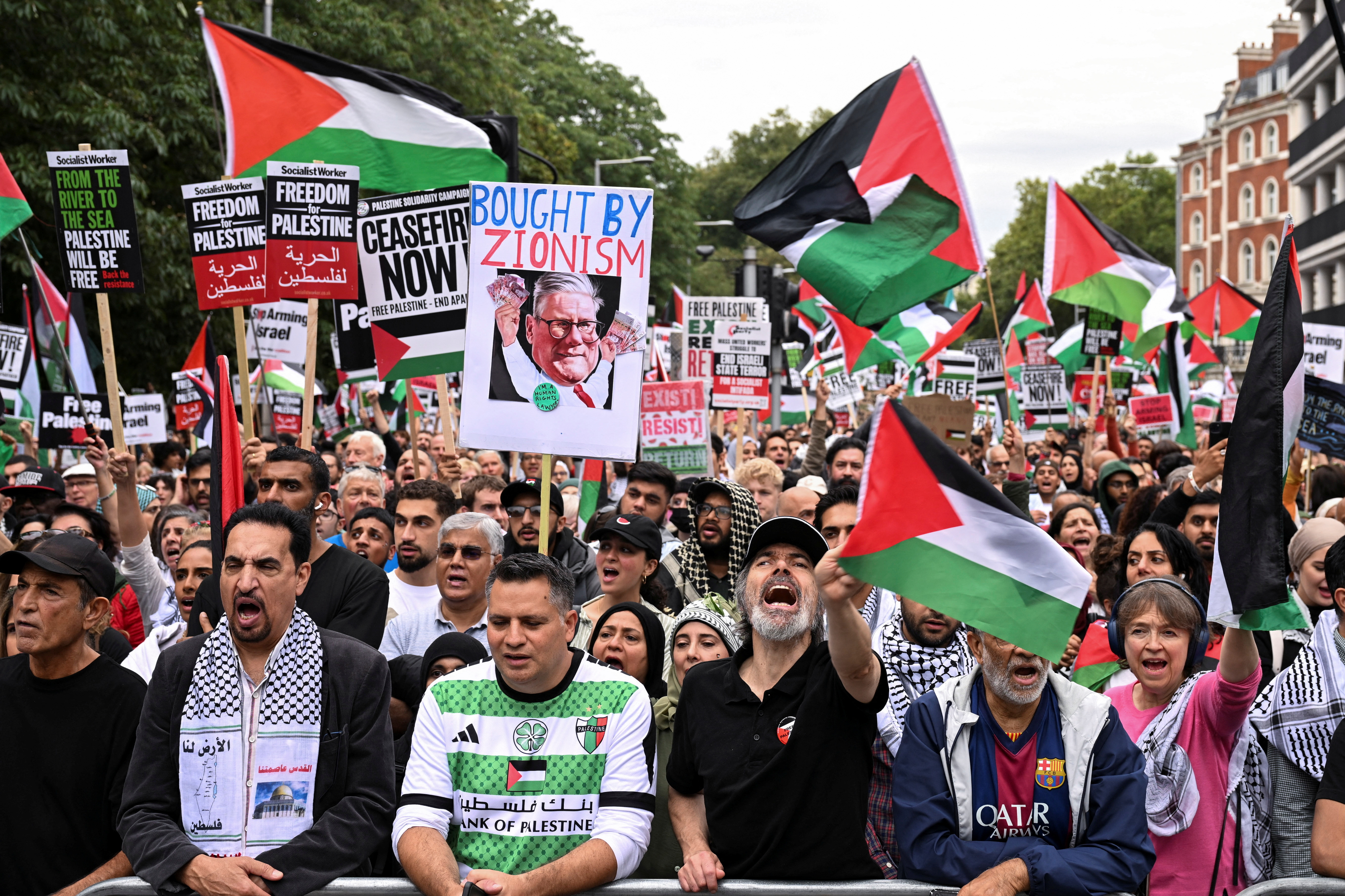 People hold signs during a demonstration in support of Palestinians in Gaza, amid the ongoing Israel-Hamas conflict, in London, Britain September 7, 2024. REUTERS/Jaimi Joy