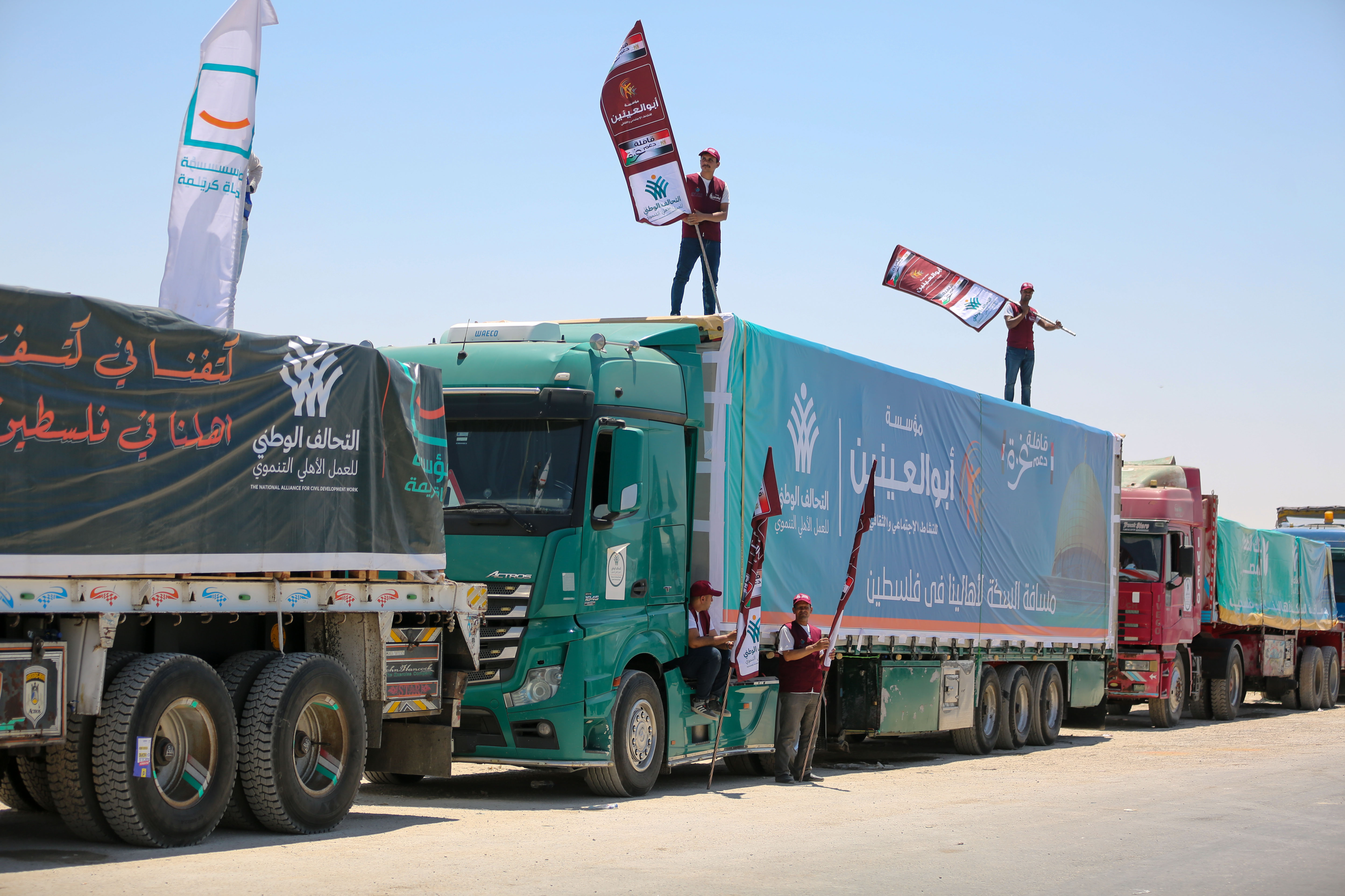 RAFAH, EGYPT - AUGUST 6: Trucks loaded with aid enter through the Rafah Border Crossing on August 6, 2025 in Rafah, Egypt. Shipments of humanitarian aid continue to trickle through the Rafah crossing during the second week of Israel's "tactical pause" in fighting in some parts of Gaza, including near the Rafah crossing. The World Food Programme has said over half a million people in Gaza are enduring famine-like conditions, with UN Human Rights Chief Volker Türk condemning the situation as "an affront to our collective humanity." (Photo by Ahmad Hasaballah/Getty Images)