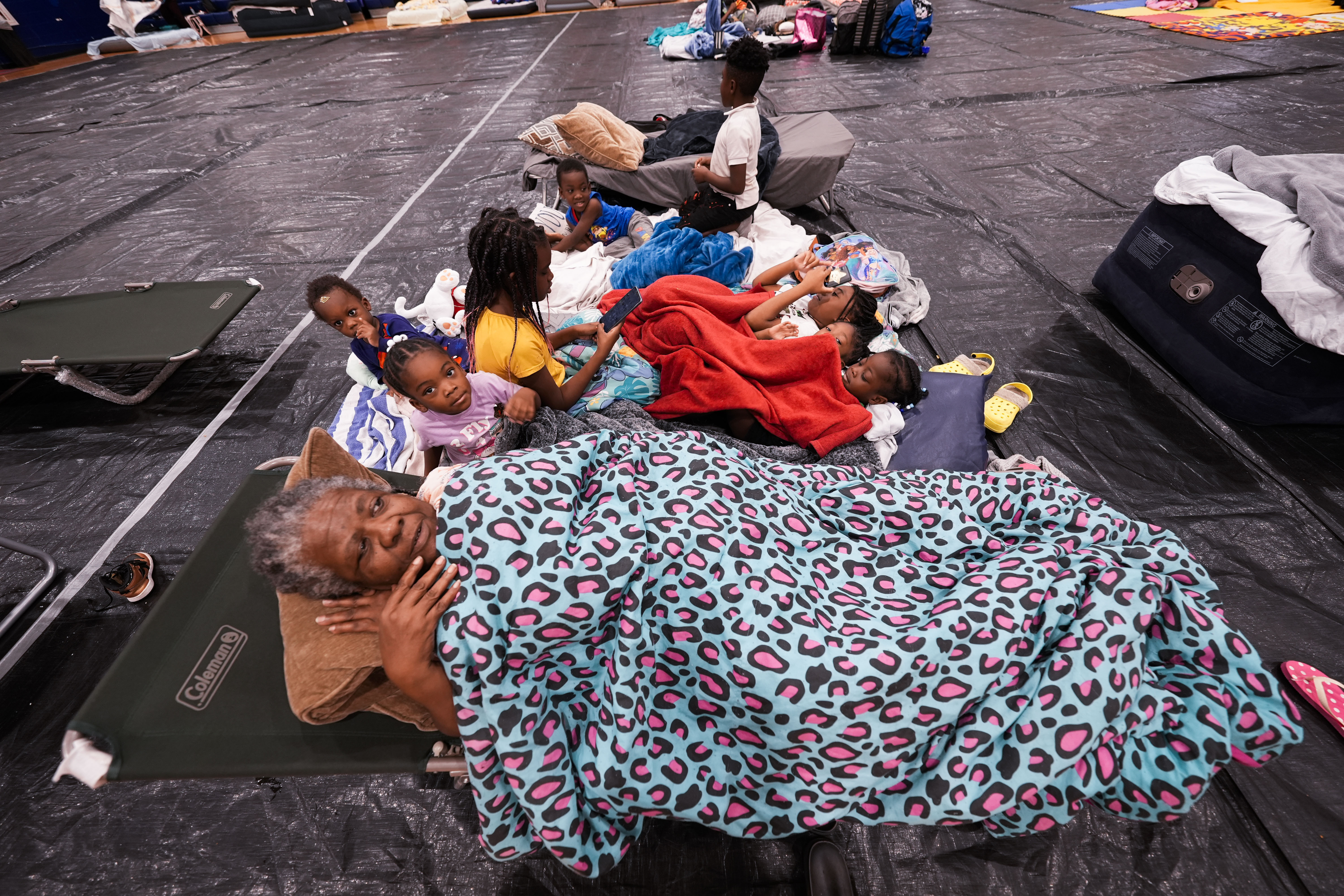 Vera Kelly, of Tallahassee, lies on a cot after evacuating to a hurricane shelter with her grandchildren and great grandchildren, at Fairview Middle School, ahead of Hurricane Helene, expected to make landfall here today, in Leon County, Fla., Thursday, Sept. 26, 2024. (AP Photo/Gerald Herbert)