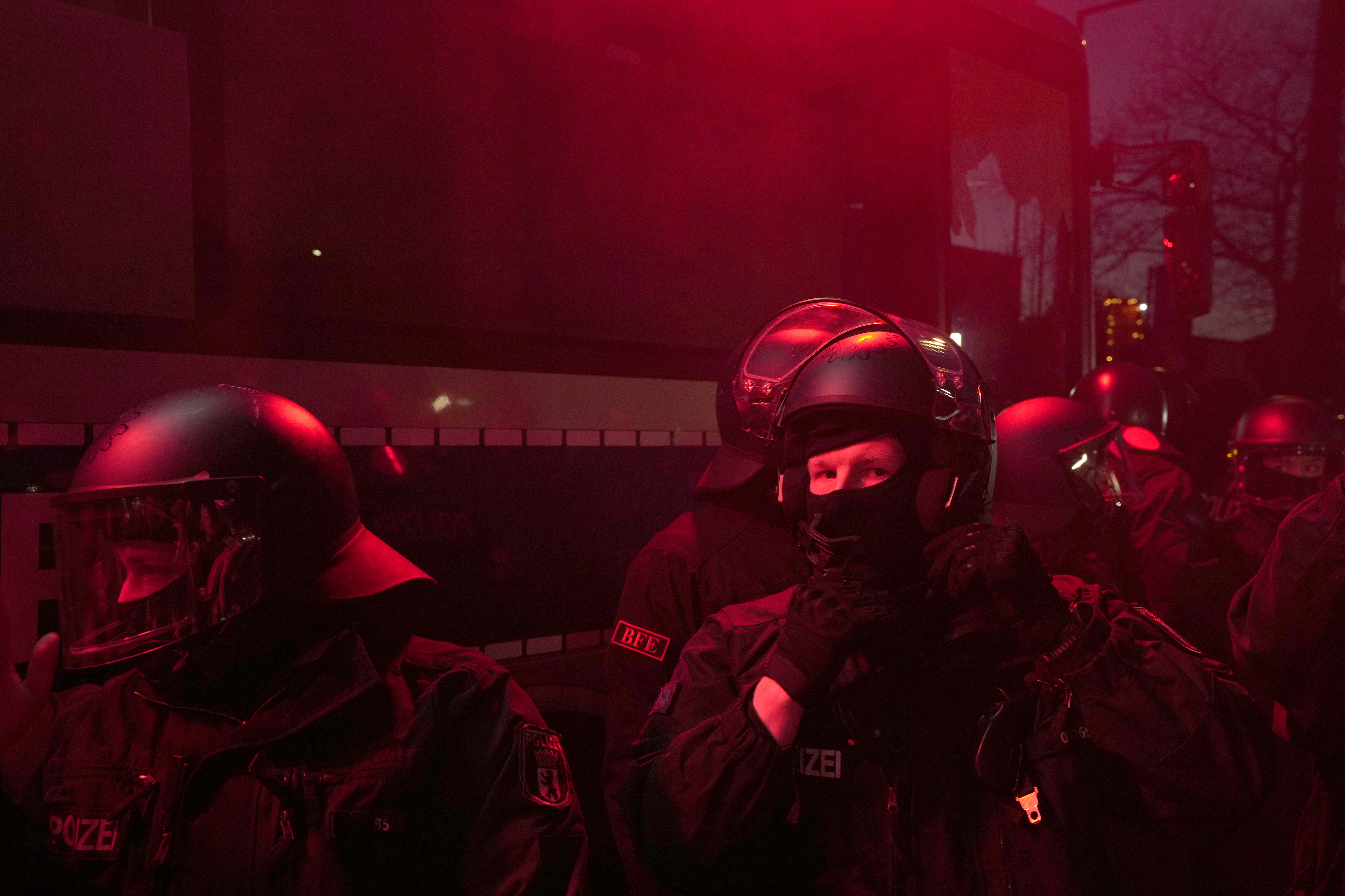 Policemen guard an area as people hold a protest near the AfD party headquarters in Berlin, Germany, Sunday, Feb. 23, 2025, after the German national election. (AP Photo/Czarek Sokolowski)