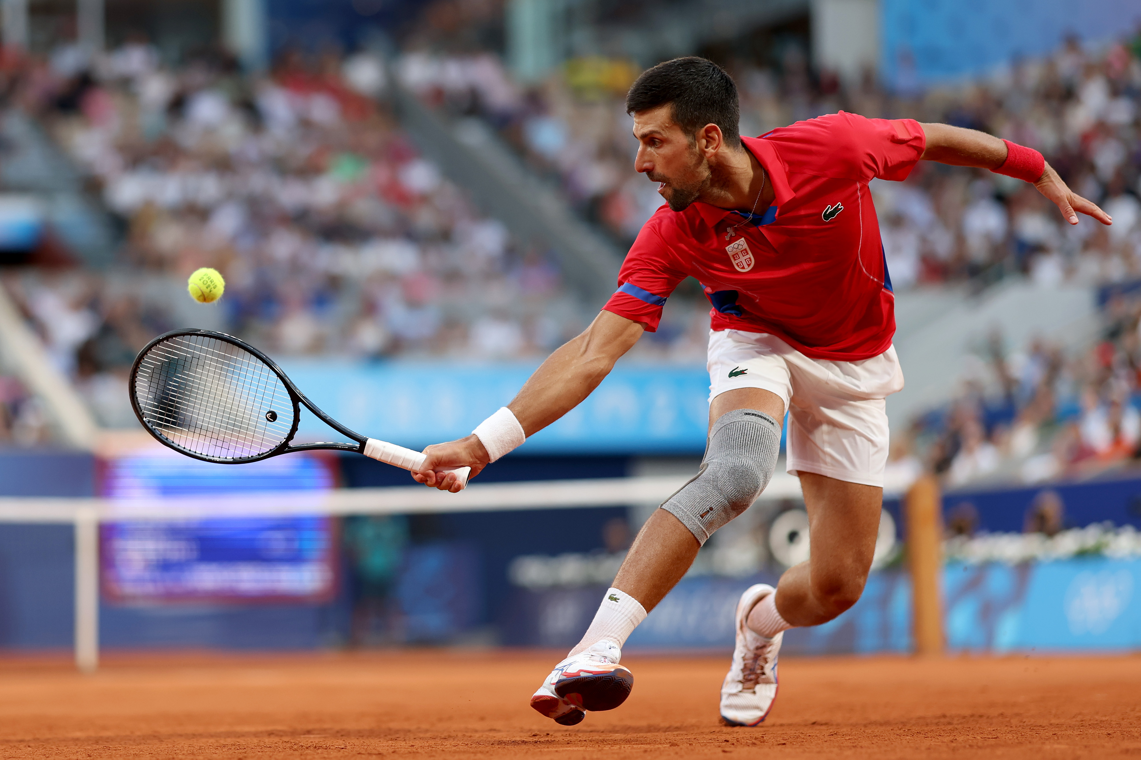 PARIS, FRANCE - AUGUST 02: Novak Djokovic of Serbia plays a backhand during the Tennis Men's Singles Semifinal match against Lorenzo Musetti of Italy on day seven of the Olympic Games Paris 2024 at Roland Garros on August 02, 2024 in Paris, France. (Photo by Clive Brunskill/Getty Images)