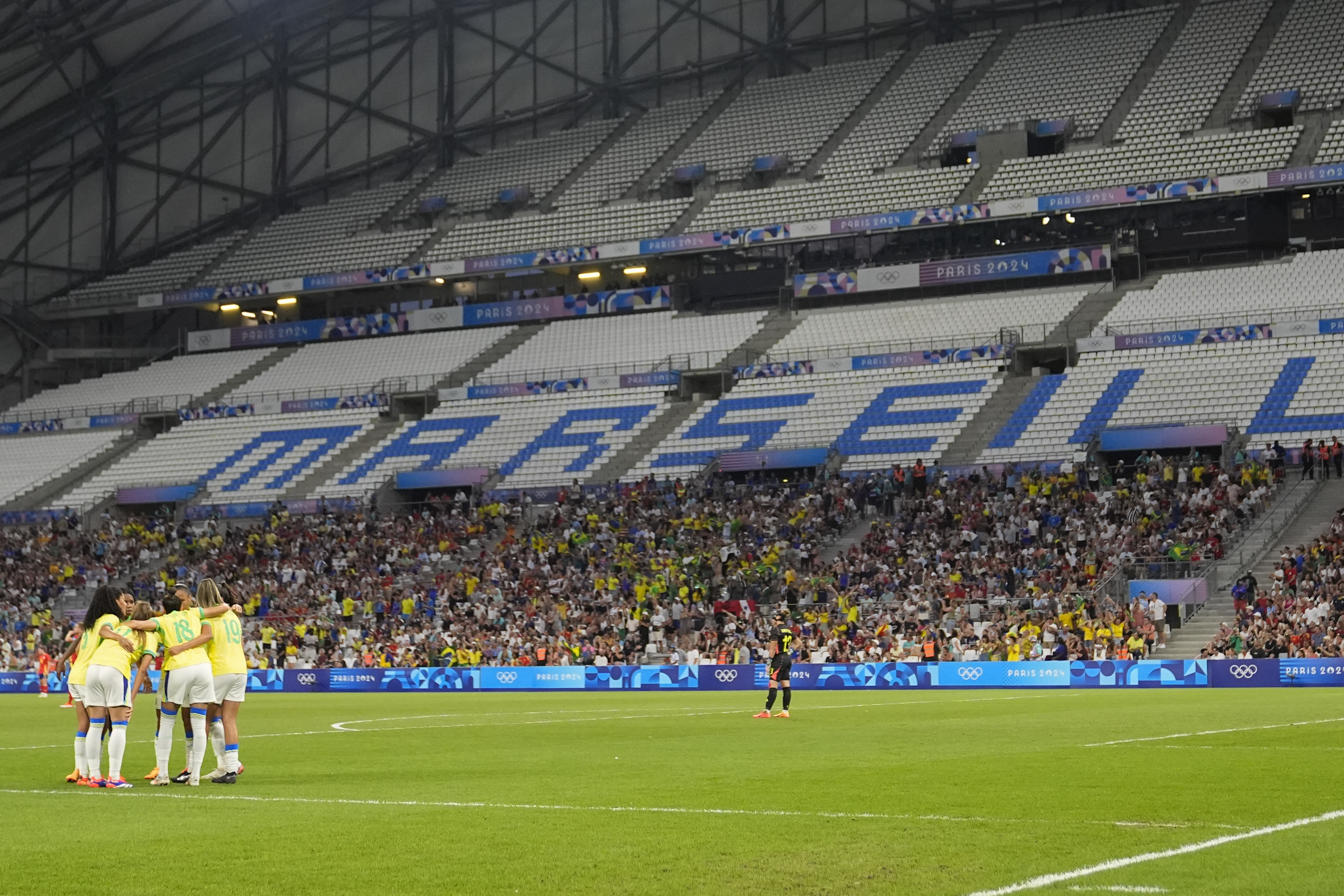 Brazilian players celebrate after Spain's Irene Paredes scored an own goal during a women's semifinal soccer match between Brazil and Spain at the 2024 Summer Olympics, Tuesday, Aug. 6, 2024, at Marseille Stadium in Marseille, France. (AP Photo/Julio Cortez)