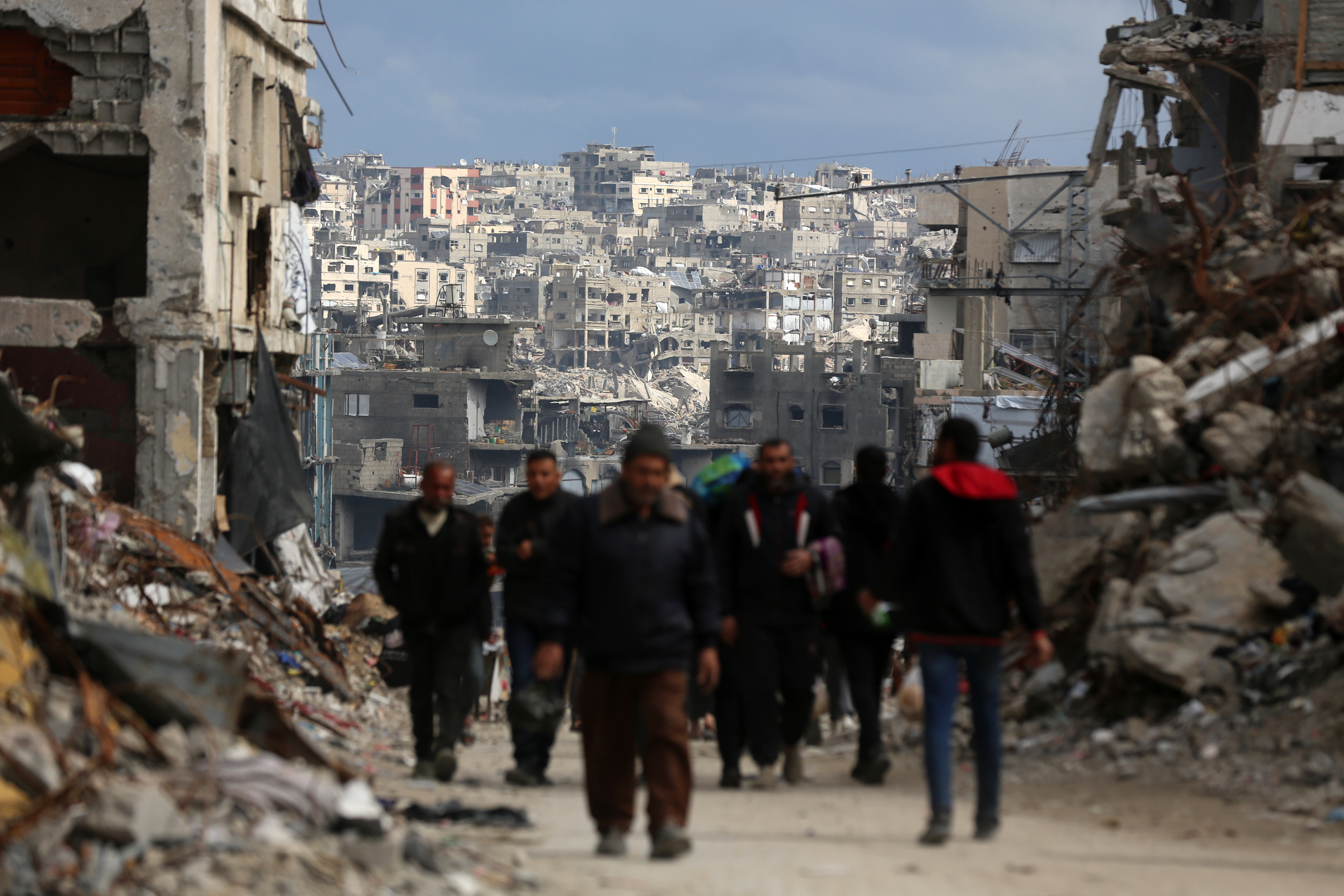 Palestinians walk amid the rubble of destroyed buildings in Jabalia, Gaza Strip, on February 21, 2025. (Photo by Majdi Fathi/NurPhoto via Getty Images)