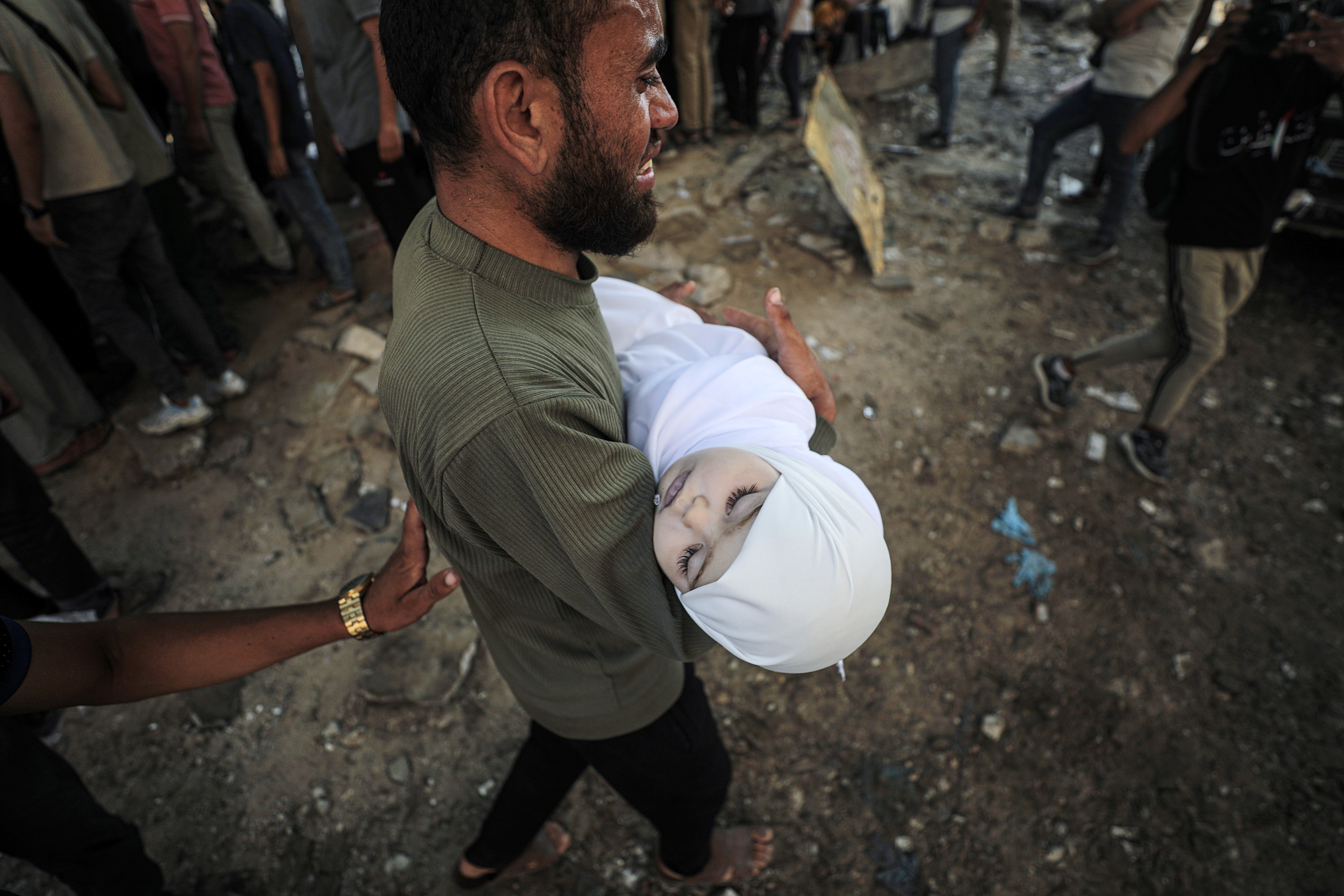 GAZA CITY (---), 23/07/2025.- A father carries the shrouded body of his child at the Al-Shifa in Gaza City, 23 July 2025. According to the Palestinian Ministry of Health in Gaza, more than 36 Palestinians were killed, ten of them from the Mushtaha family, following Israeli airstrikes last night and early today. EFE/EPA/MOHAMMED SABER