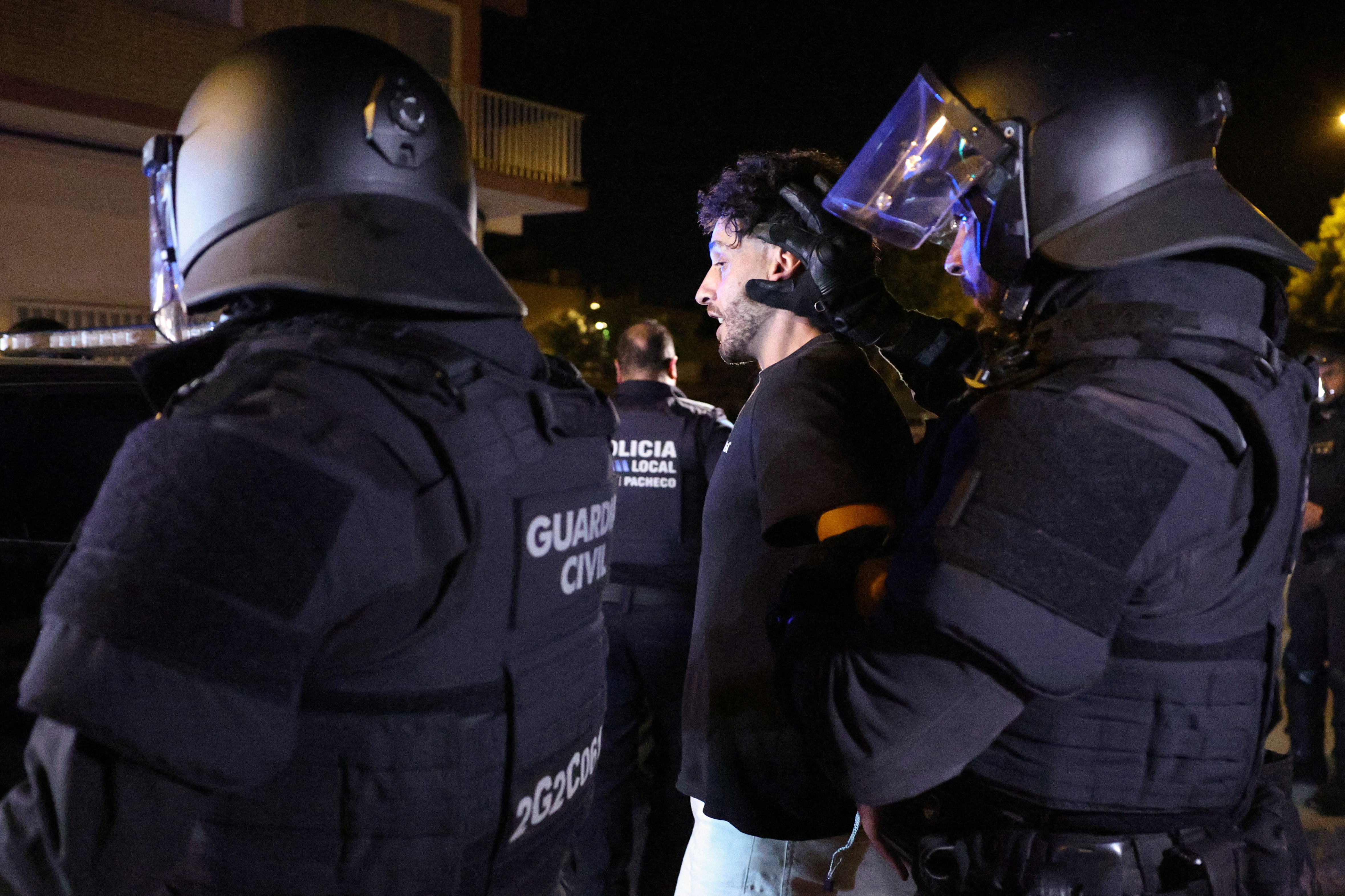 A person is detained by riot police officers, amid anti-migrant unrest following an attack on an elderly man by unknown assailants earlier in the week, in Torre Pacheco, Spain, July 15, 2025. REUTERS/Violeta Santos Moura TPX IMAGES OF THE DAY