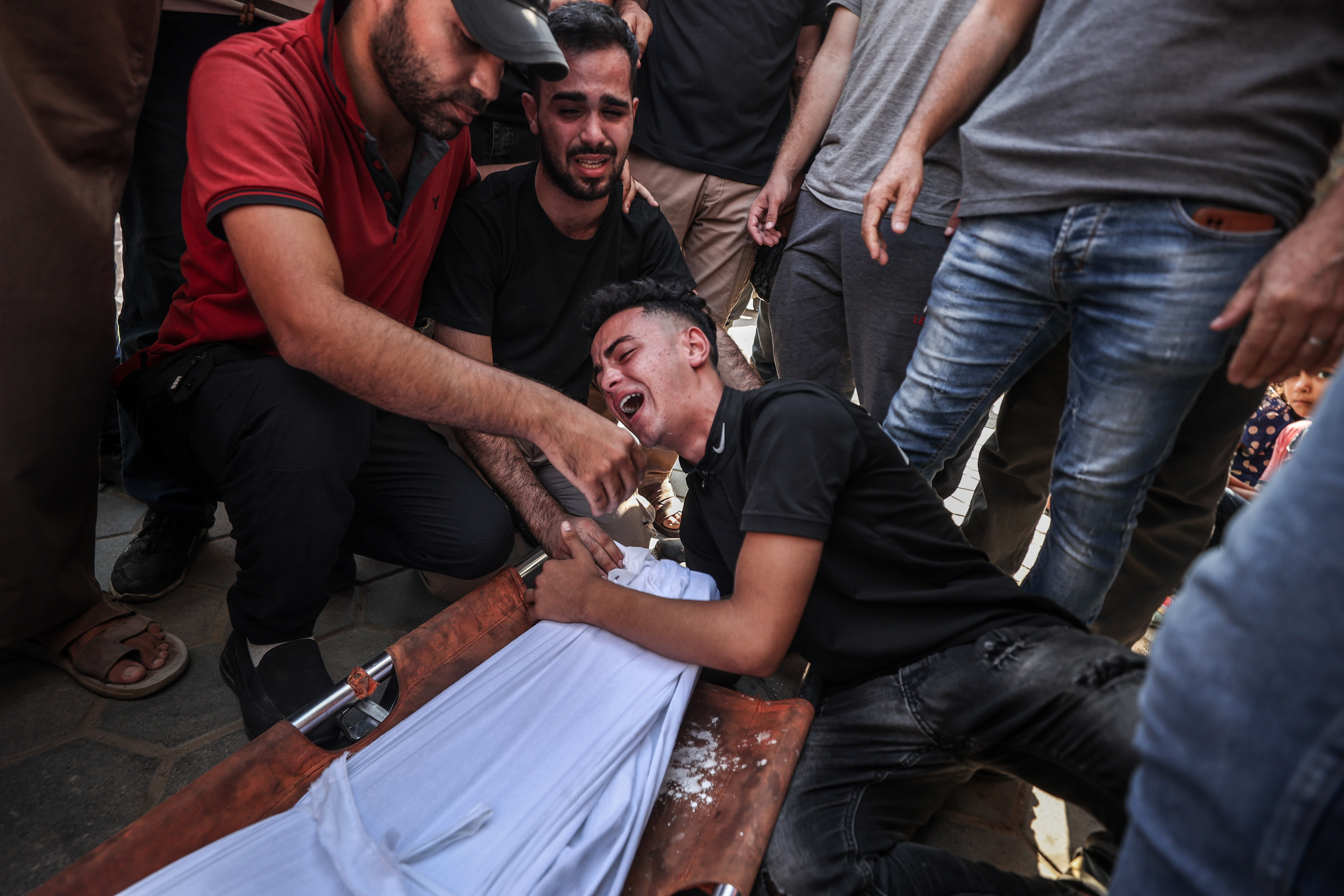 DEIR AL BALAH, GAZA - AUGUST 01: Relatives of the deceased mourn their loss as the bodies are brought to Al Aqsa Martyrs Hospital for funeral prayer and burial after at least 5 Palestinians died in an Israeli attack on Maghazi refugee camp in Deir al Balah, Gaza on August 01, 2024. (Photo by Ali Jadallah/Anadolu via Getty Images)