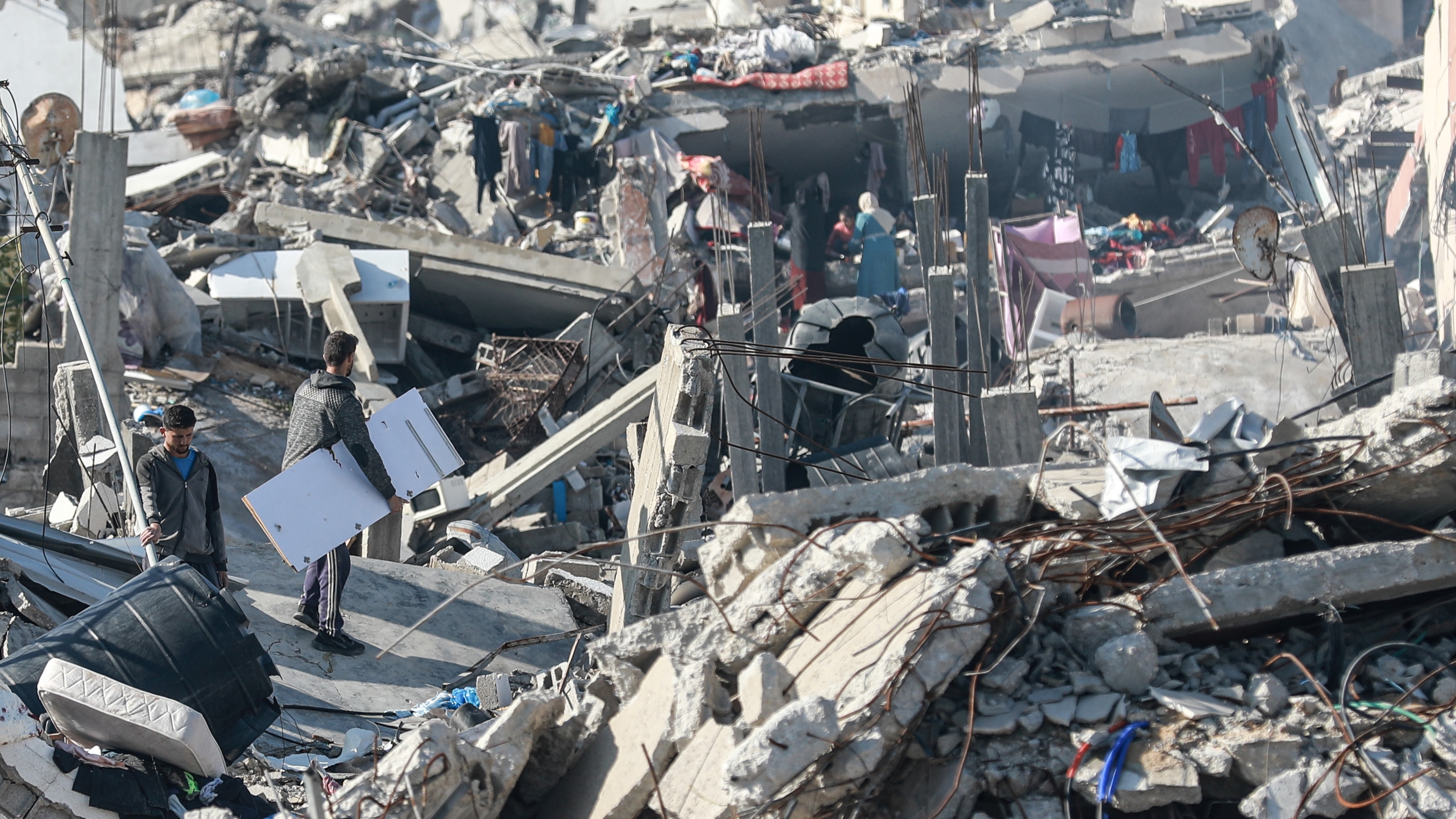 Un grupo de palestinos intenta volver a la normalidad en medio de la destrucción dejada por los ataques israelíes, este viernes en Beit Lahia.