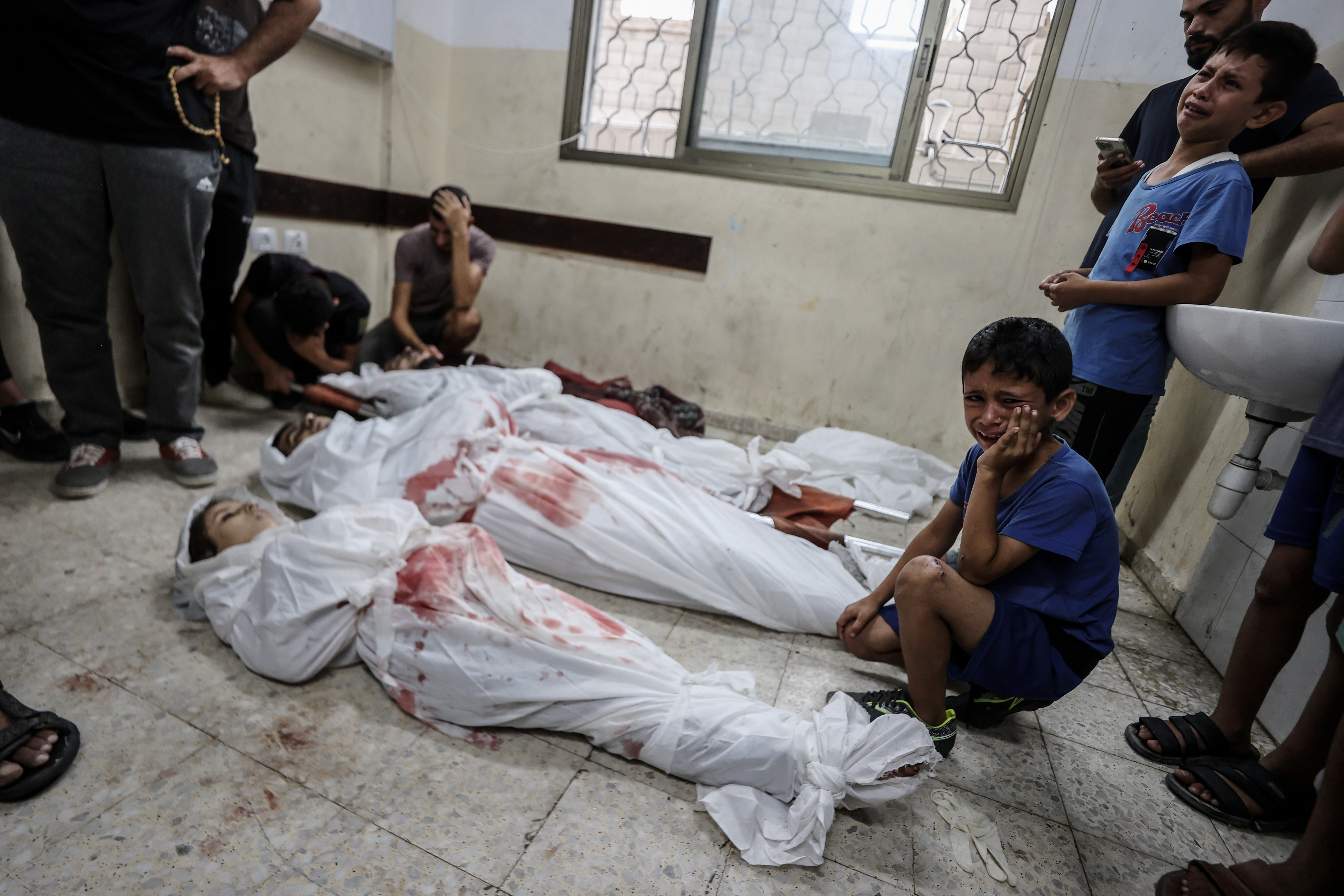 GAZA CITY, GAZA - SEPTEMBER 17: (EDITORS NOTE: Image depicts death) Palestinians who lost their relatives due to the Israeli attacks mourn, at Al-Awda Hospital in northern Gaza on September 17, 2024. The Israeli army attacked a house belonging to the Al Tartory family in Nuseirat Refugee Camp in the central part of the Gaza Strip, killing and wounding Palestinians. The bodies of those who lost their lives in the attack, including children, were brought to Al-Awda Hospital in the camp for funeral procedures. (Photo by Ali Jadallah/Anadolu via Getty Images)