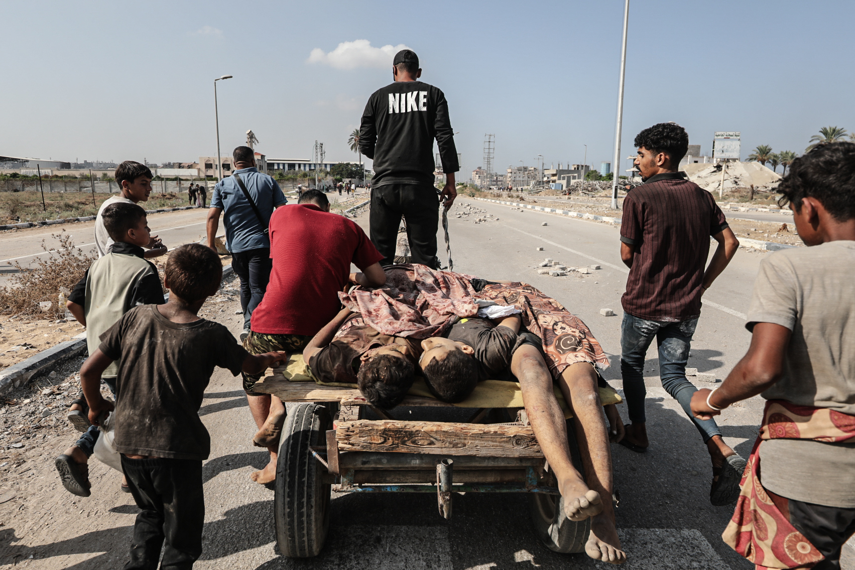 GAZA CITY, GAZA - SEPTEMBER 26: (EDITORS NOTE: Image depicts death) Bodies of Palestinians, who lost their lives in Israel's attacks while waiting for aid in the Netzarim Corridor, are taken away by other Palestinians in the area in Gaza City, Gaza on September 26, 2025. As a result of the shooting, 11 Palestinians were killed and many others were injured. (Photo by Moiz Salhi/Anadolu via Getty Images)