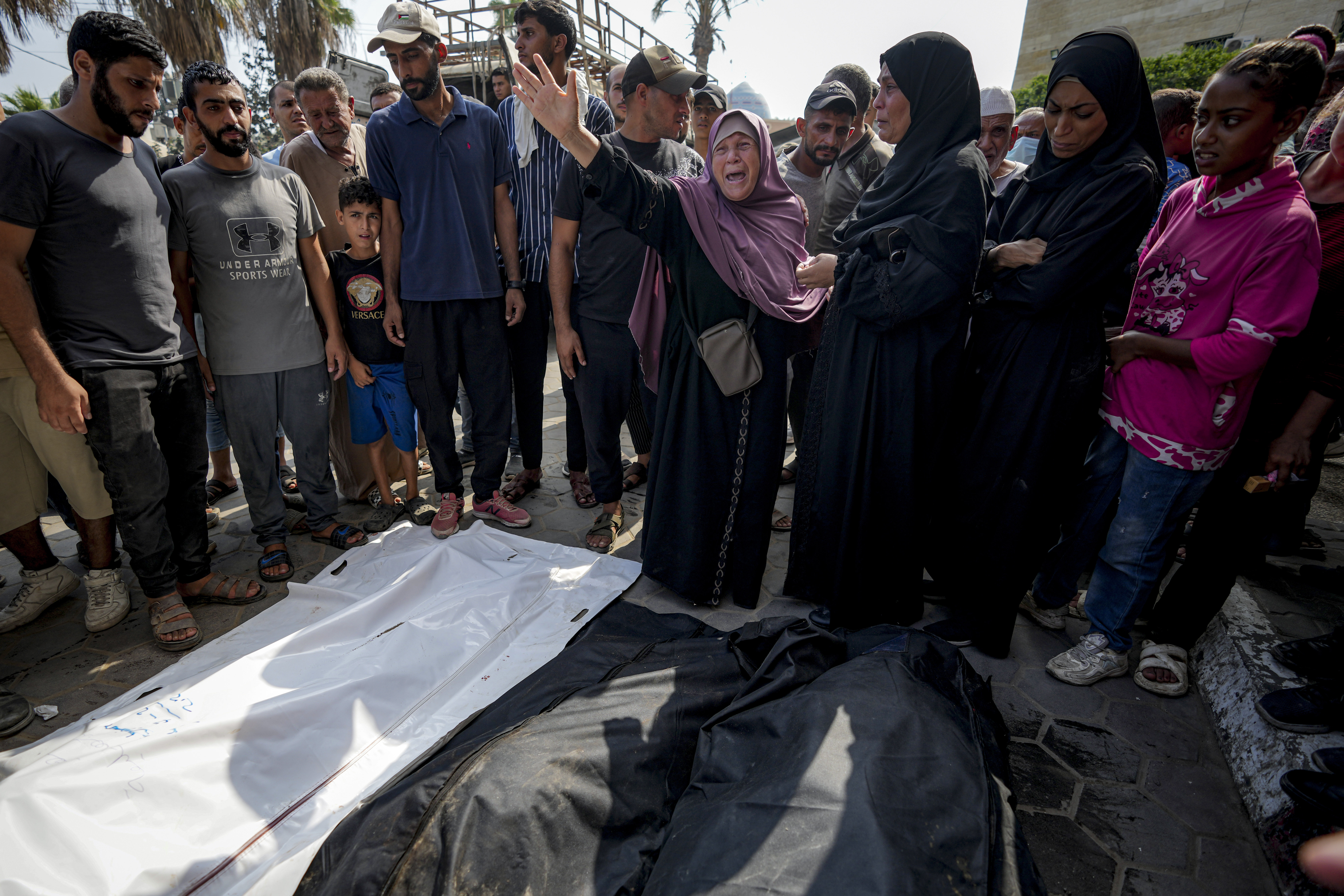 Palestinians mourn their relatives killed in the Israeli bombardment of the Gaza Strip in a hospital in Deir al-Balah, Sunday, July 21, 2024. (AP Photo/Abdel Kareem Hana)