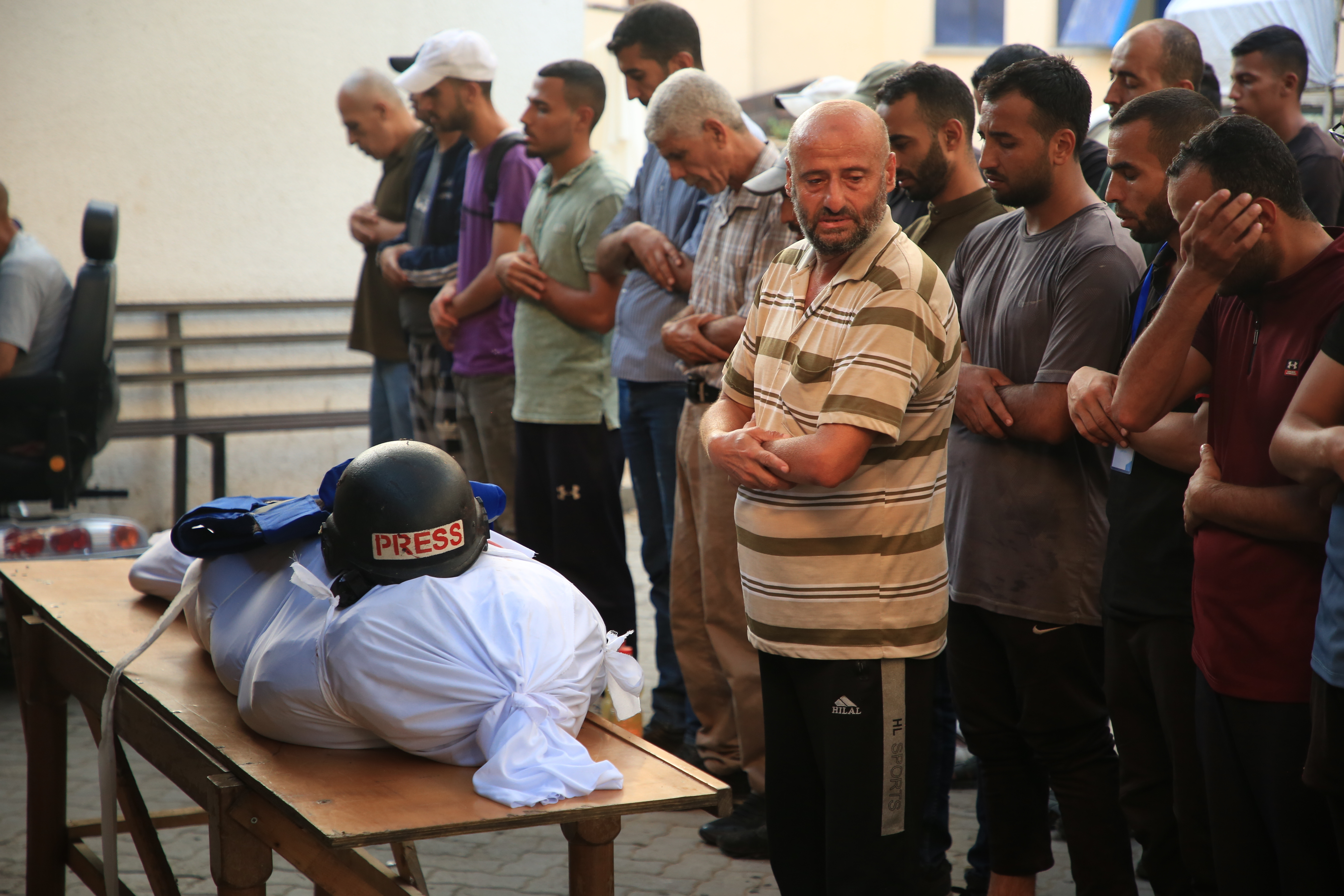 GAZA CITY, GAZA - OCTOBER 9: People perform funeral prayers for Al-Aqsa TV cameraman Mohammed al-Tanani, who lost his life during Israeli attack on the Jabalia Refugee Camp, as the body is brought to al-Aqsa Baptist Hospital in Gaza City, Gaza on October 9, 2024. (Photo by Hamza Z. H. Qraiqea/Anadolu via Getty Images)