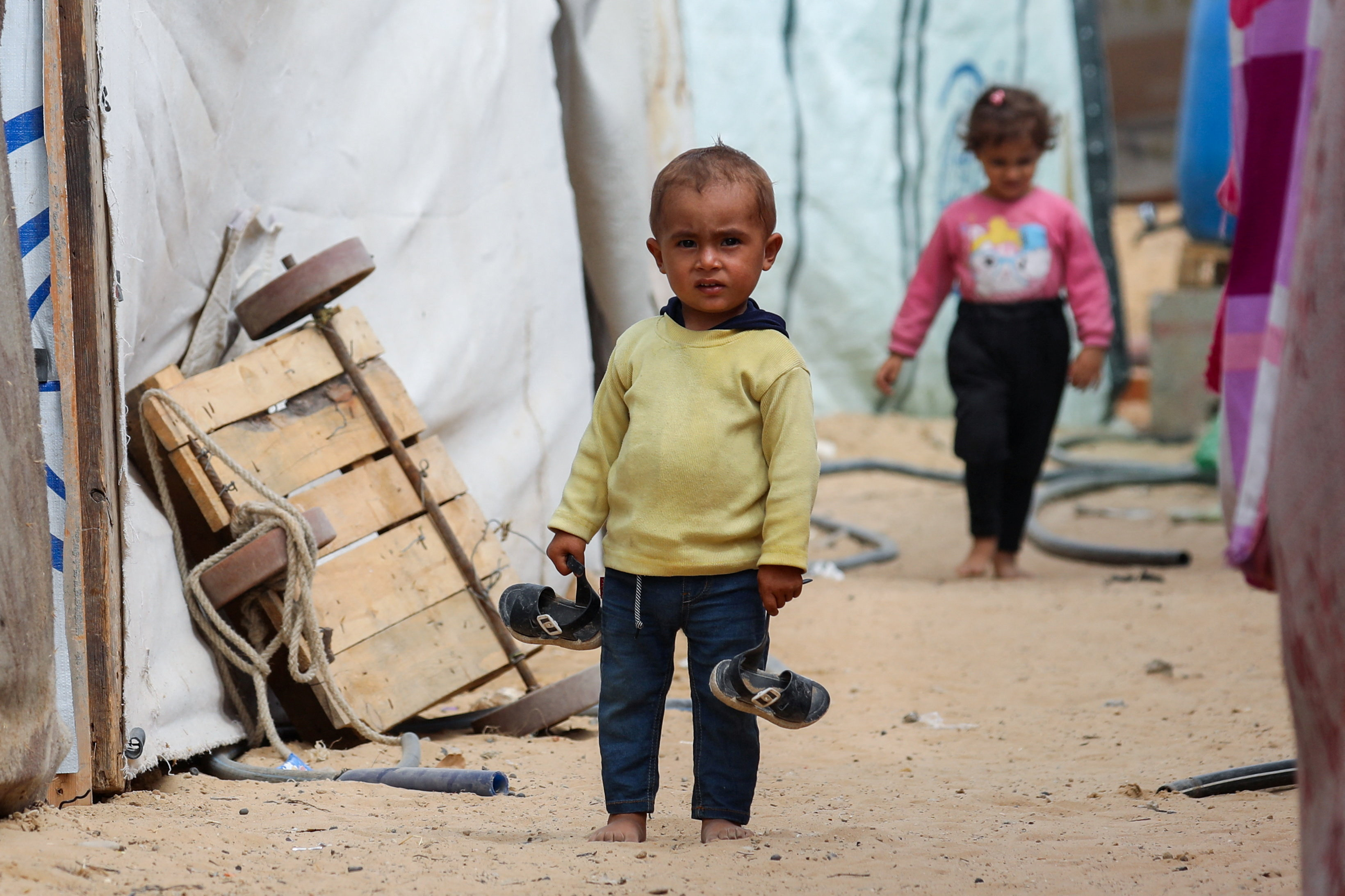 A Palestinian child stands between tents as displaced Palestinians, who fled northern Gaza due to an Israeli military operation, shelter in the central Gaza Strip, October 6, 2025. REUTERS/Dawoud Abu Alkas     TPX IMAGES OF THE DAY     