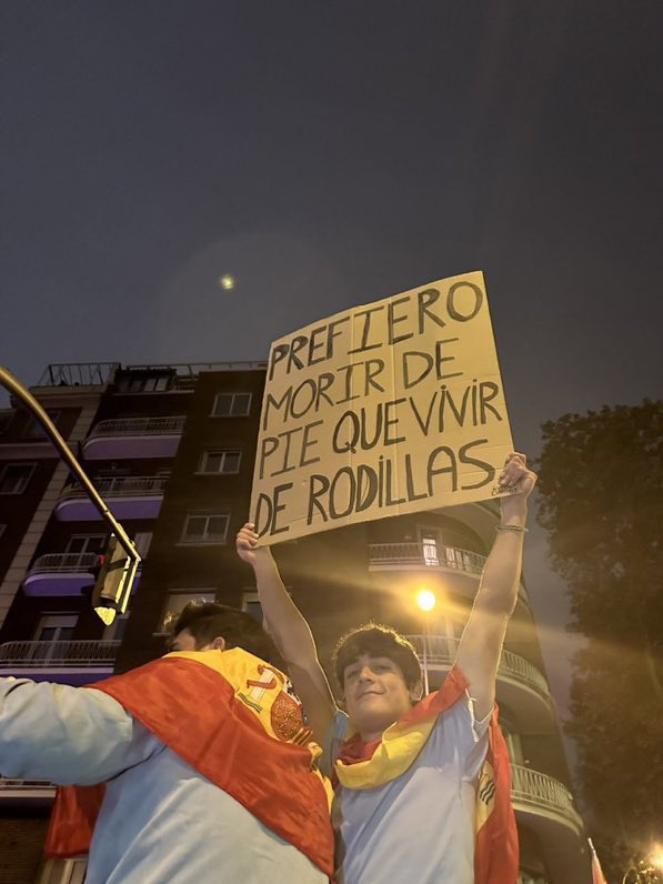 Un manifestante en la calle Ferraz sostiene un cartel de 