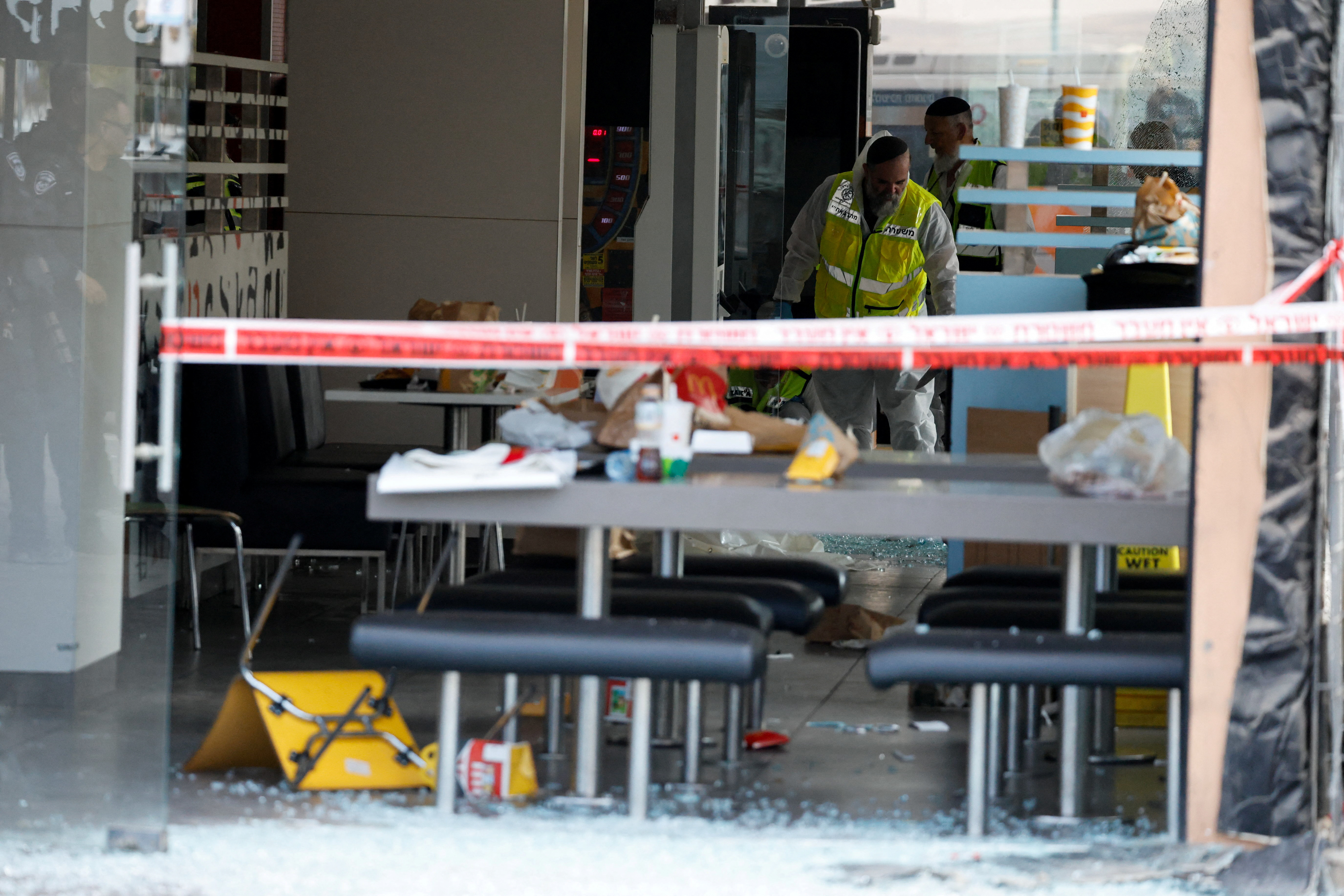 Members of rescue unit ZAKA work at the scene of an attack in Beersheba, southern Israel, October 6, 2024. REUTERS/Amir Cohen