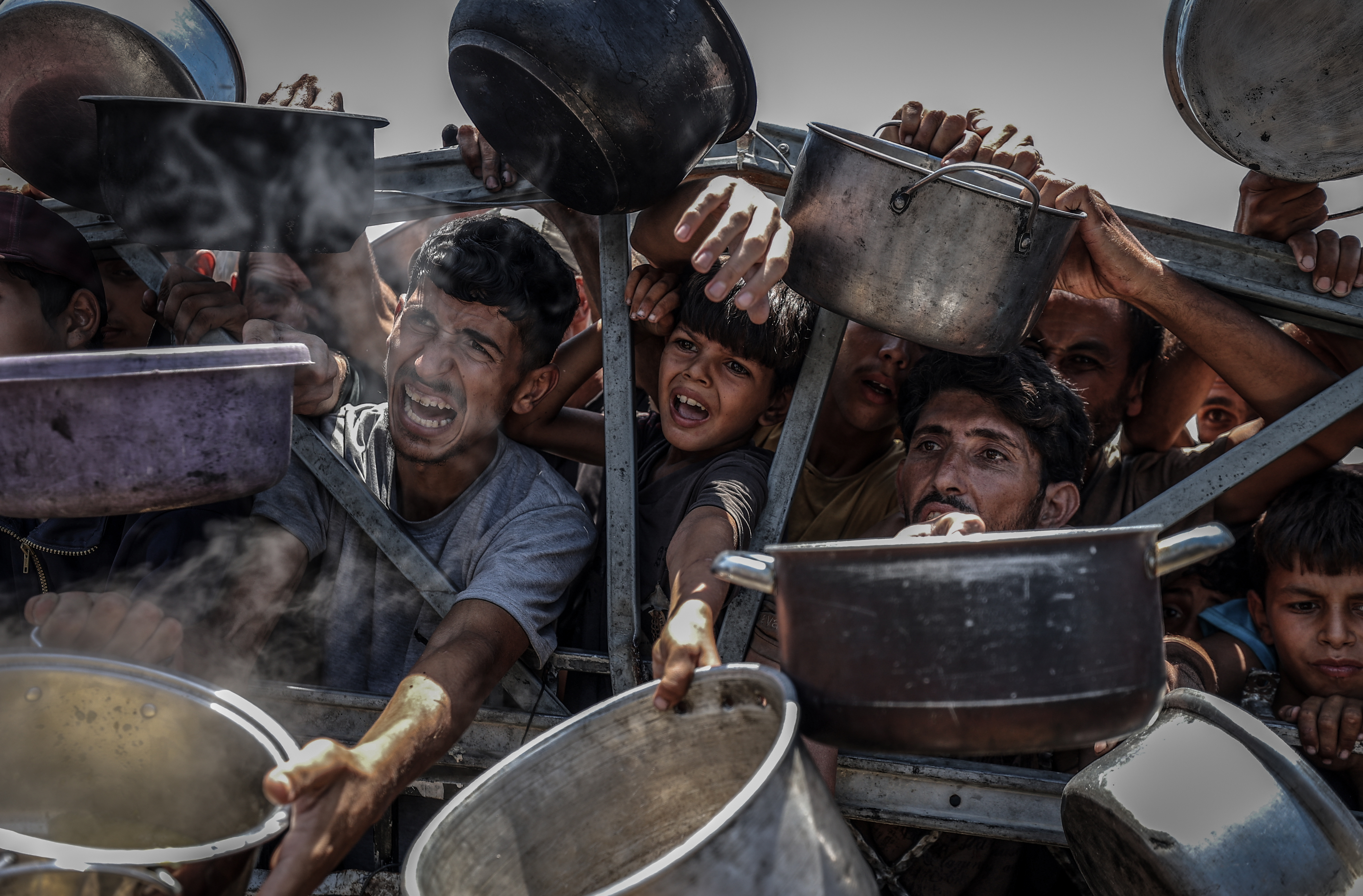 GAZA CITY, GAZA - JULY 22: Crowds form as Palestinians, including children, line up in Gaza City, Gaza to receive food distributed by a charity amid ongoing Israeli blockade and attacks on Gaza on July 22, 2025. (Photo by Ali Jadallah/Anadolu via Getty Images)