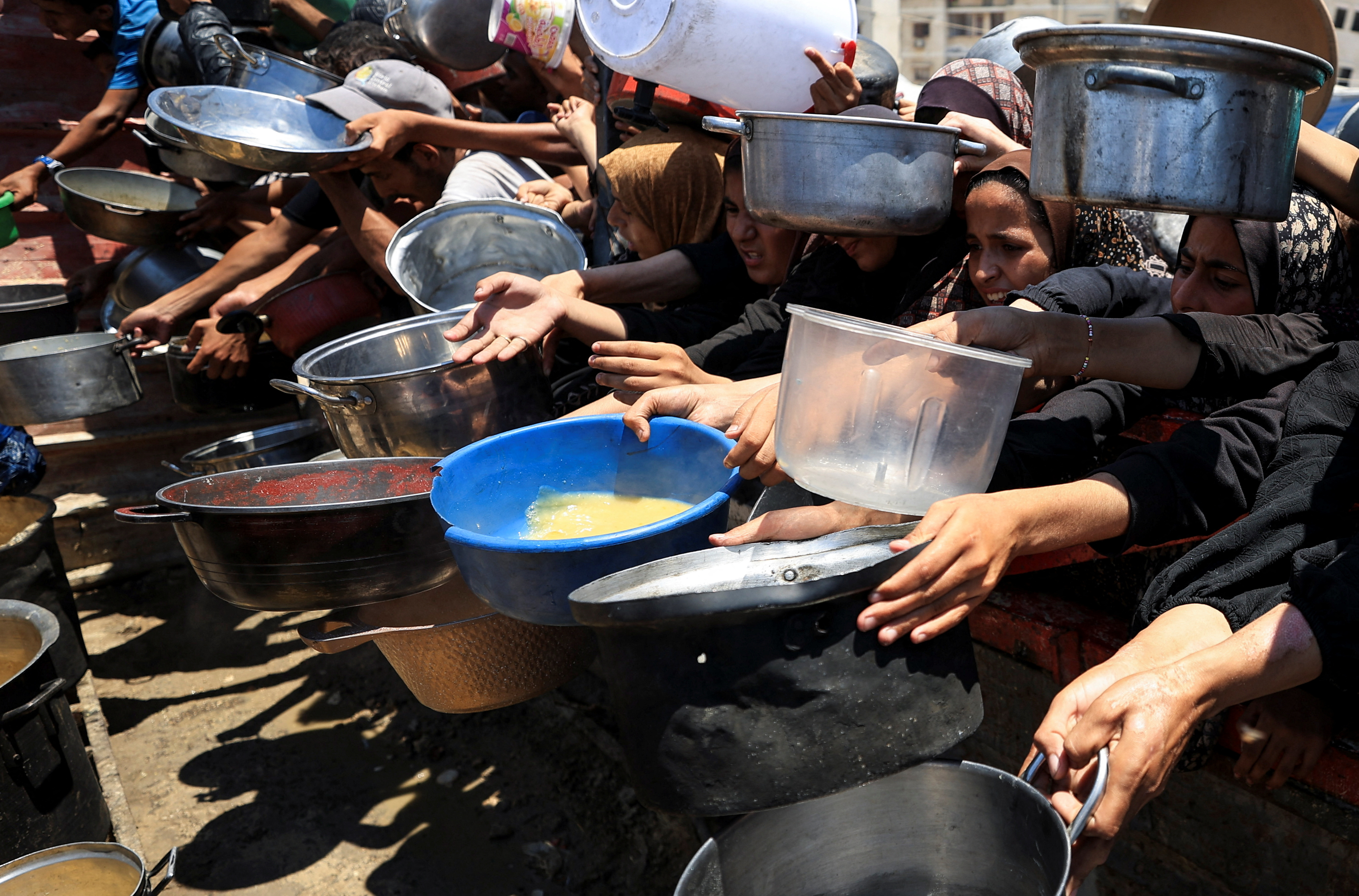 Palestinians gather to receive food from a charity kitchen, amid a hunger crisis, in Gaza City, July 24, 2025. REUTERS/Dawoud Abu Alkas