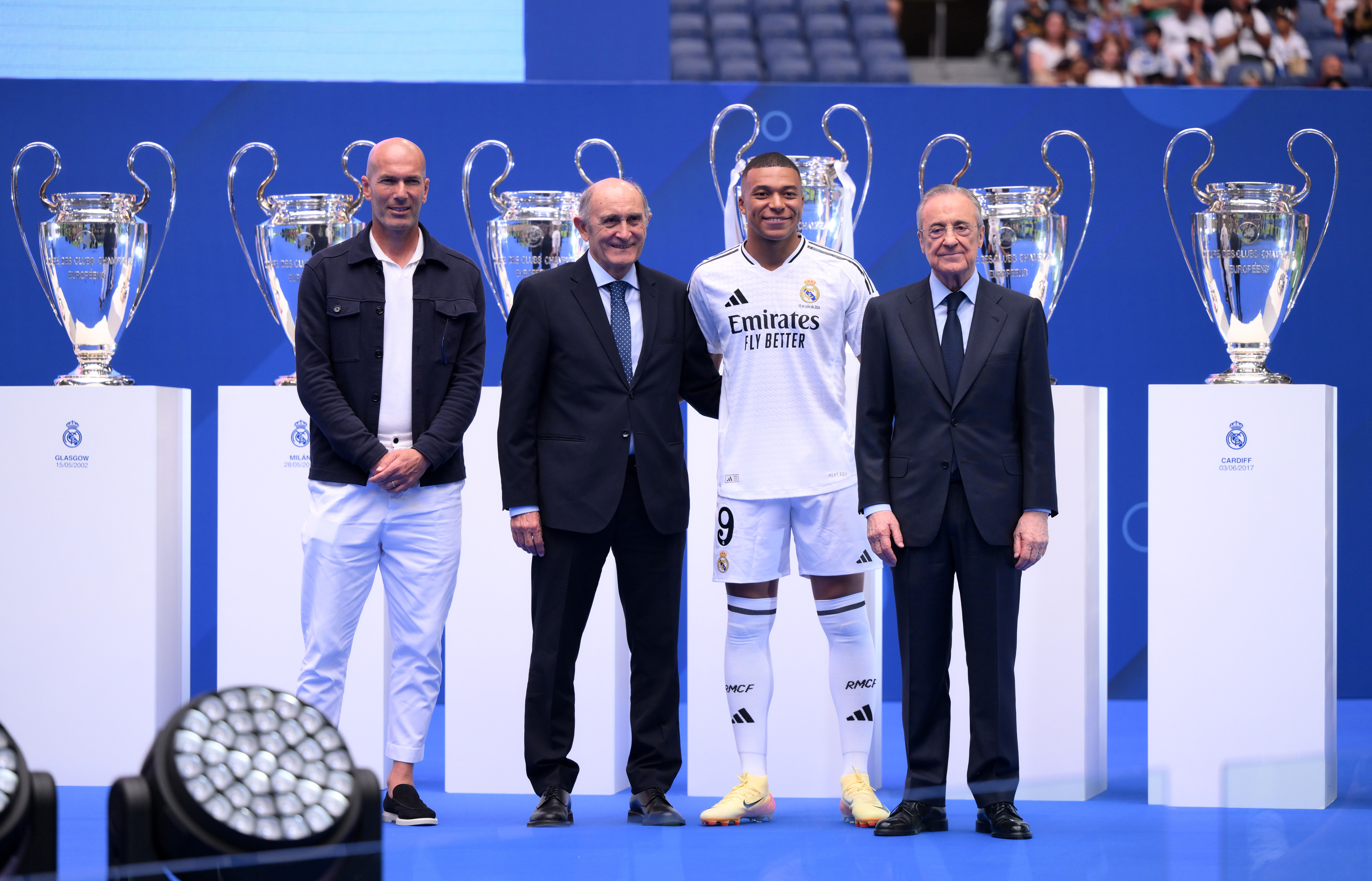 MADRID, SPAIN - JULY 16: Real Madrid new signing, Kylian Mbappe (2R) poses for a photo with former Real Madrid player and coach, Zinedine Zidane (L), former Real Madrid player, Pirri (2L) and President of Real Madrid, Florentino Perez Rodriguez (R) as he is unveiled at Estadio Santiago Bernabeu on July 16, 2024 in Madrid, Spain. (Photo by David Ramos/Getty Images)