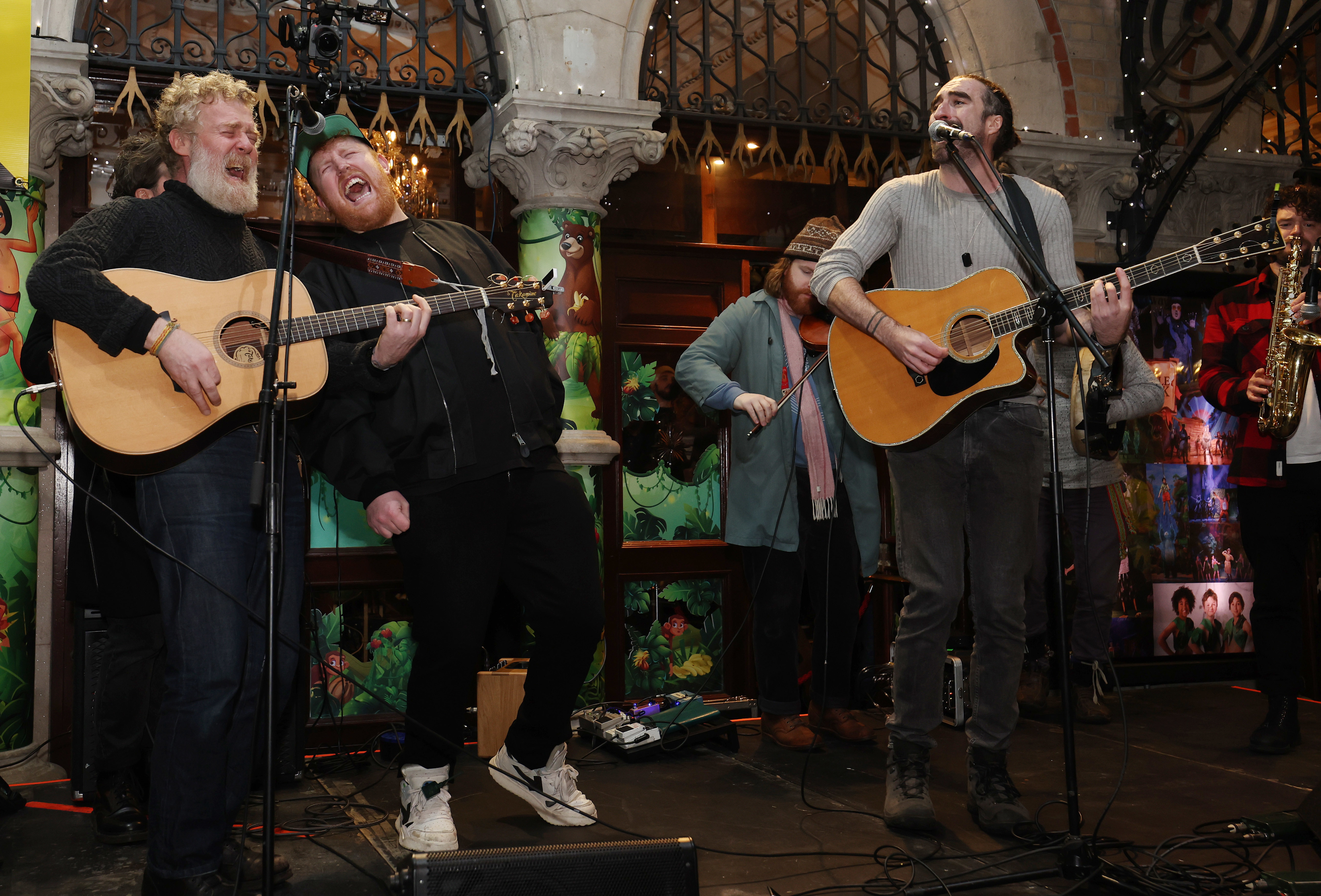 Glen Hansard, Gavin James and Danny O' Reilly busk on Grafton Street in Dublin. PA