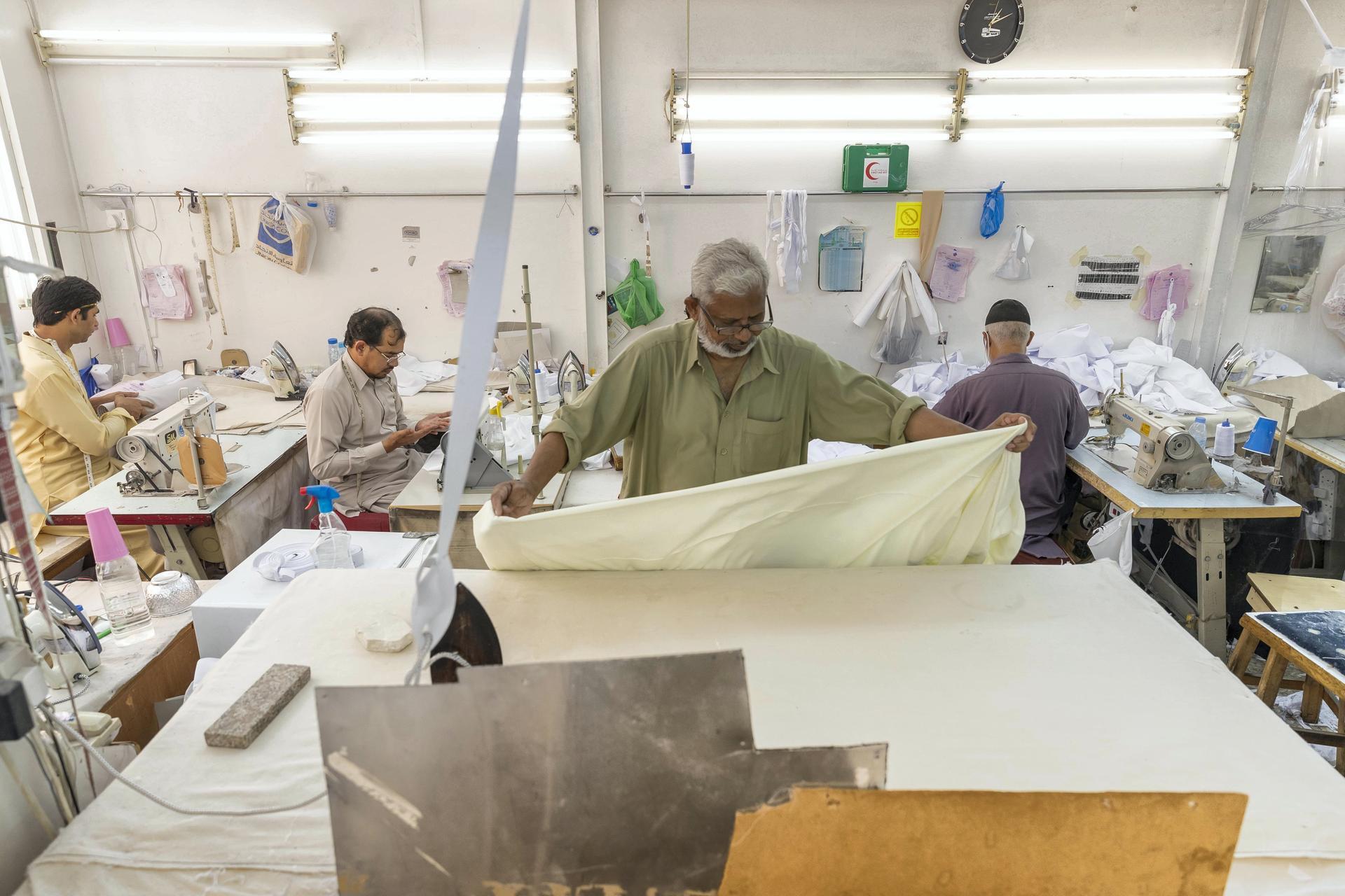 Tailors at a garment shop in Satwa prepare and finish sowing Eid clothes for the upcoming end of the Holy Month of Ramadan. Antonie Robertson / The National