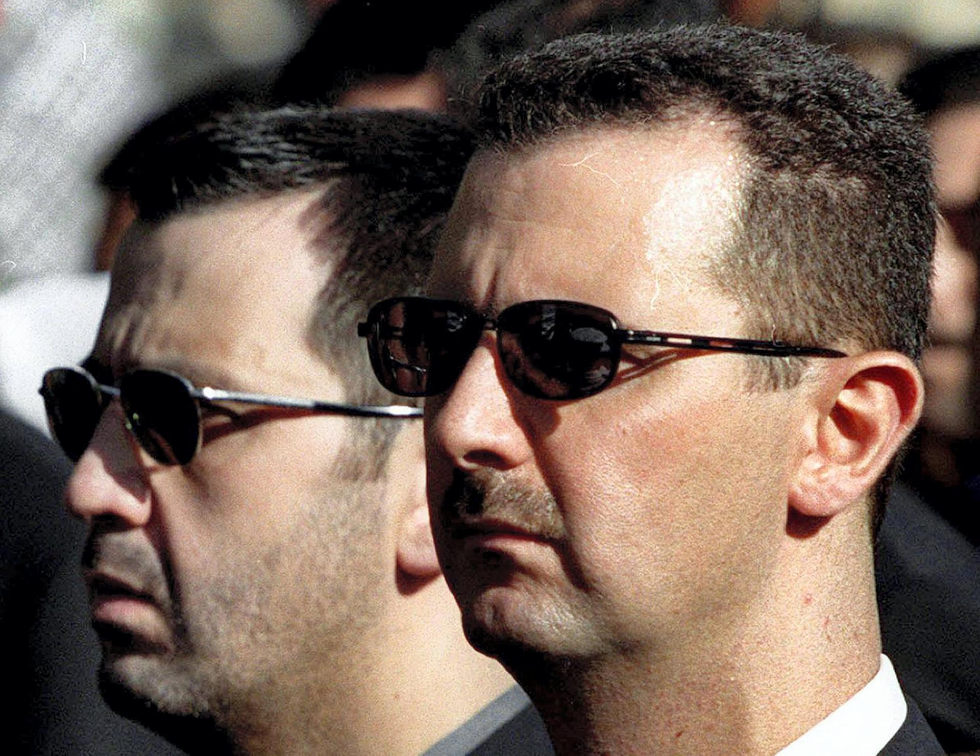Bashar al-Assad (R) and his brother Maher Al Assad, the two brothers seen as after their tycoon cousin, Rami Makhlouf. AFP