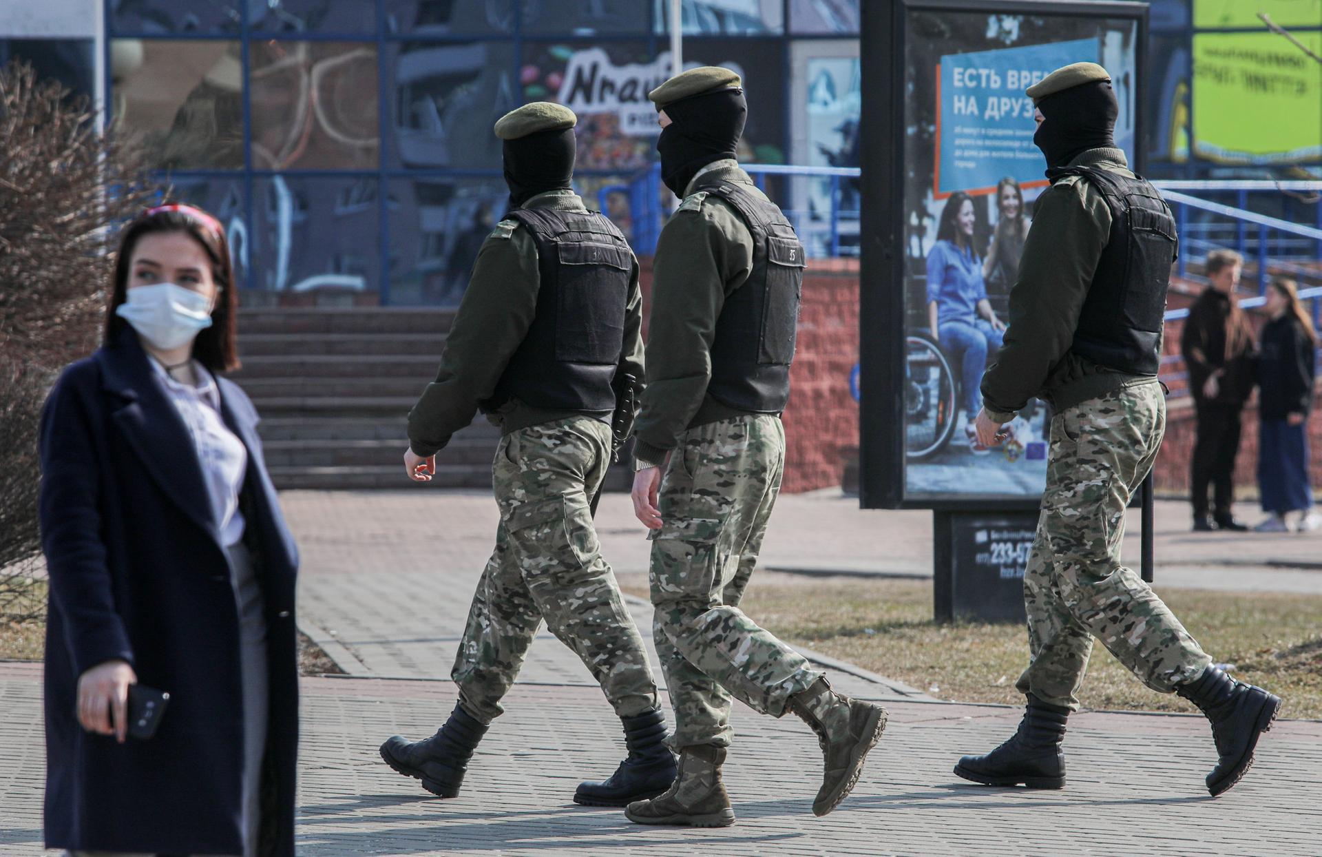 Belarusian law enforcement officers patrol a street as opposition supporters gather for a rally against President Alexander Lukashenko. Reuters.